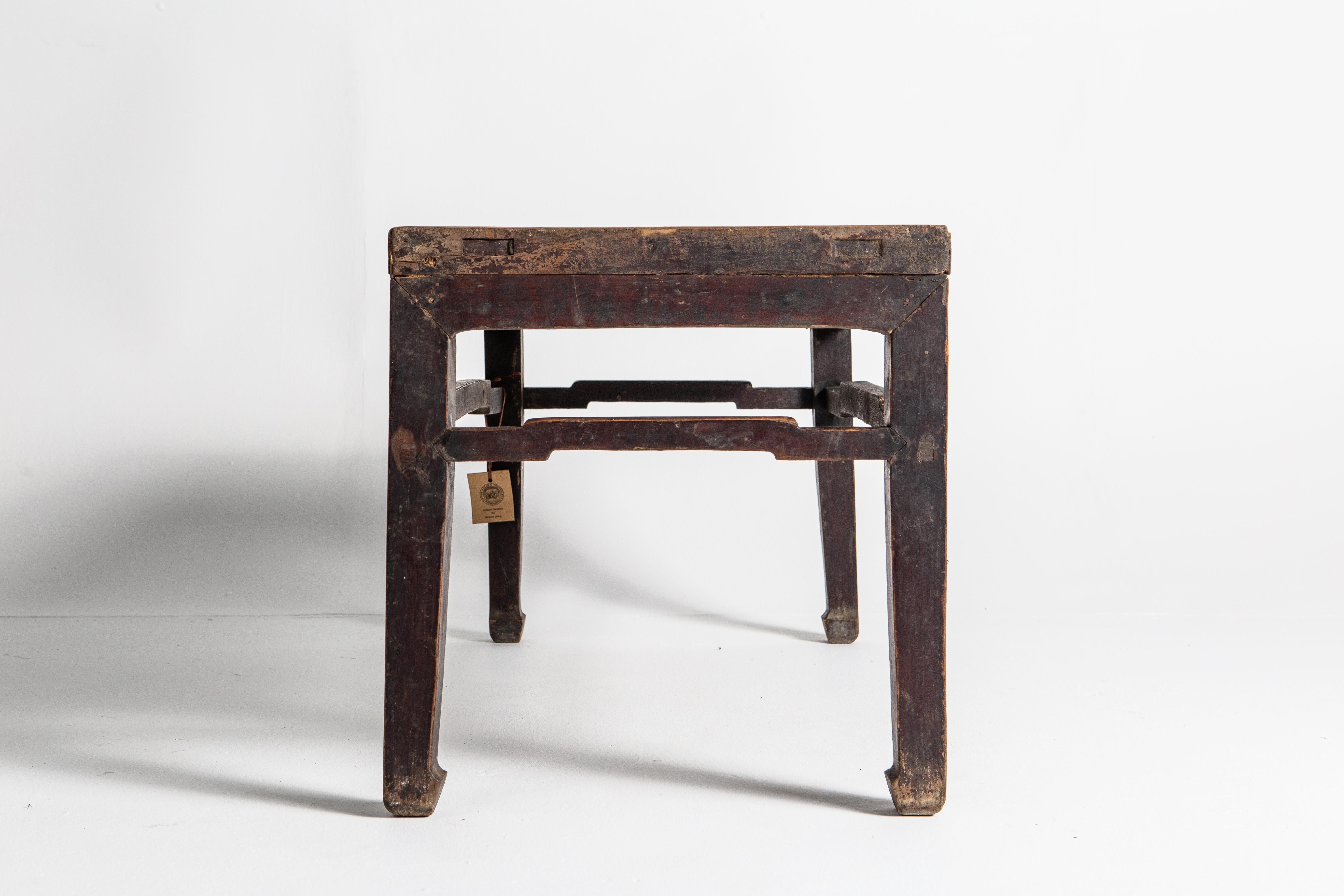 This table dates back to the Qing dynasty and was made from elm wood. The table features a beautiful aged patina; the lacquer is visibly worn on the elm wood top.