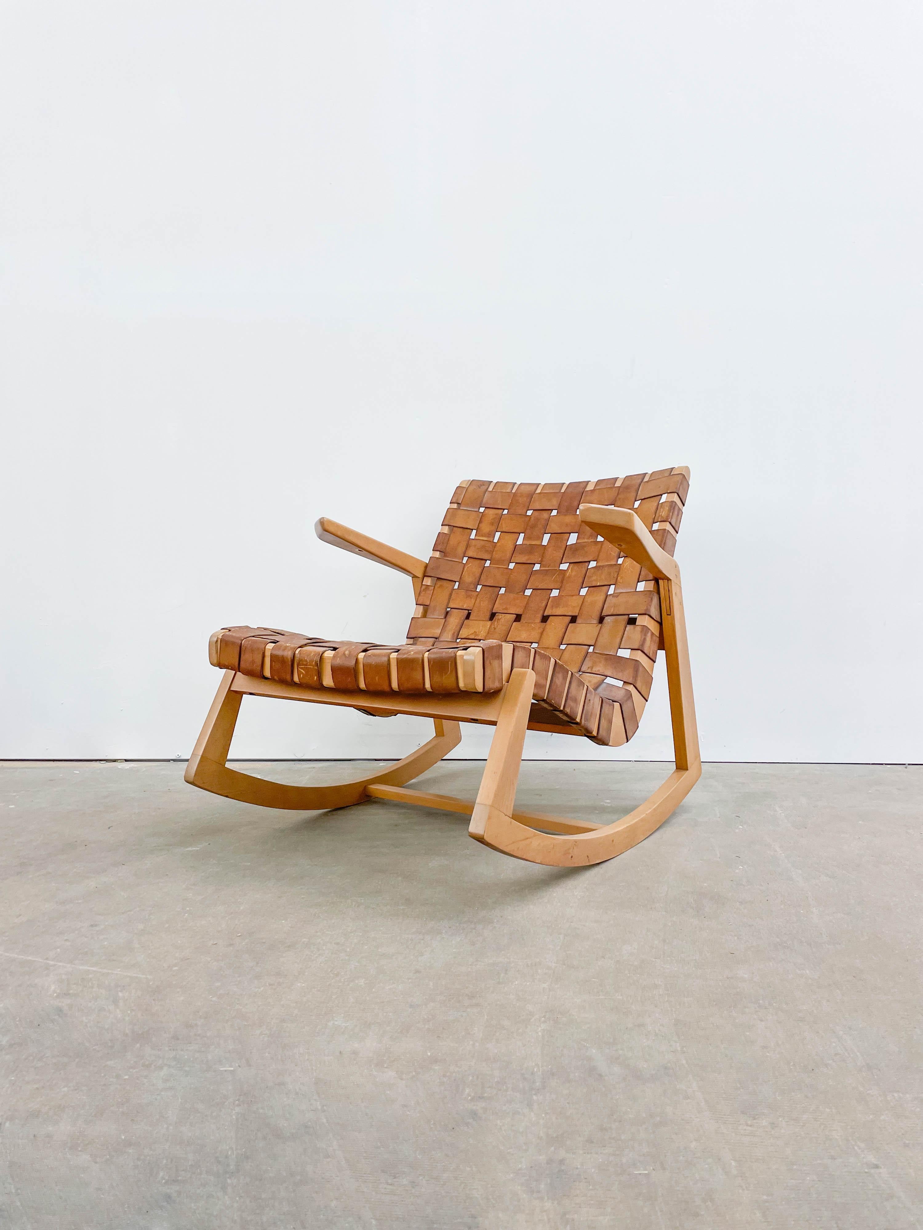 This is a rare first year production from HG Knoll Associates of a stunning rocking chair designed by Ralph Rapson. It boasts a solid birch frame with original woven leather webbing showing great patina. This particular chair comes from an