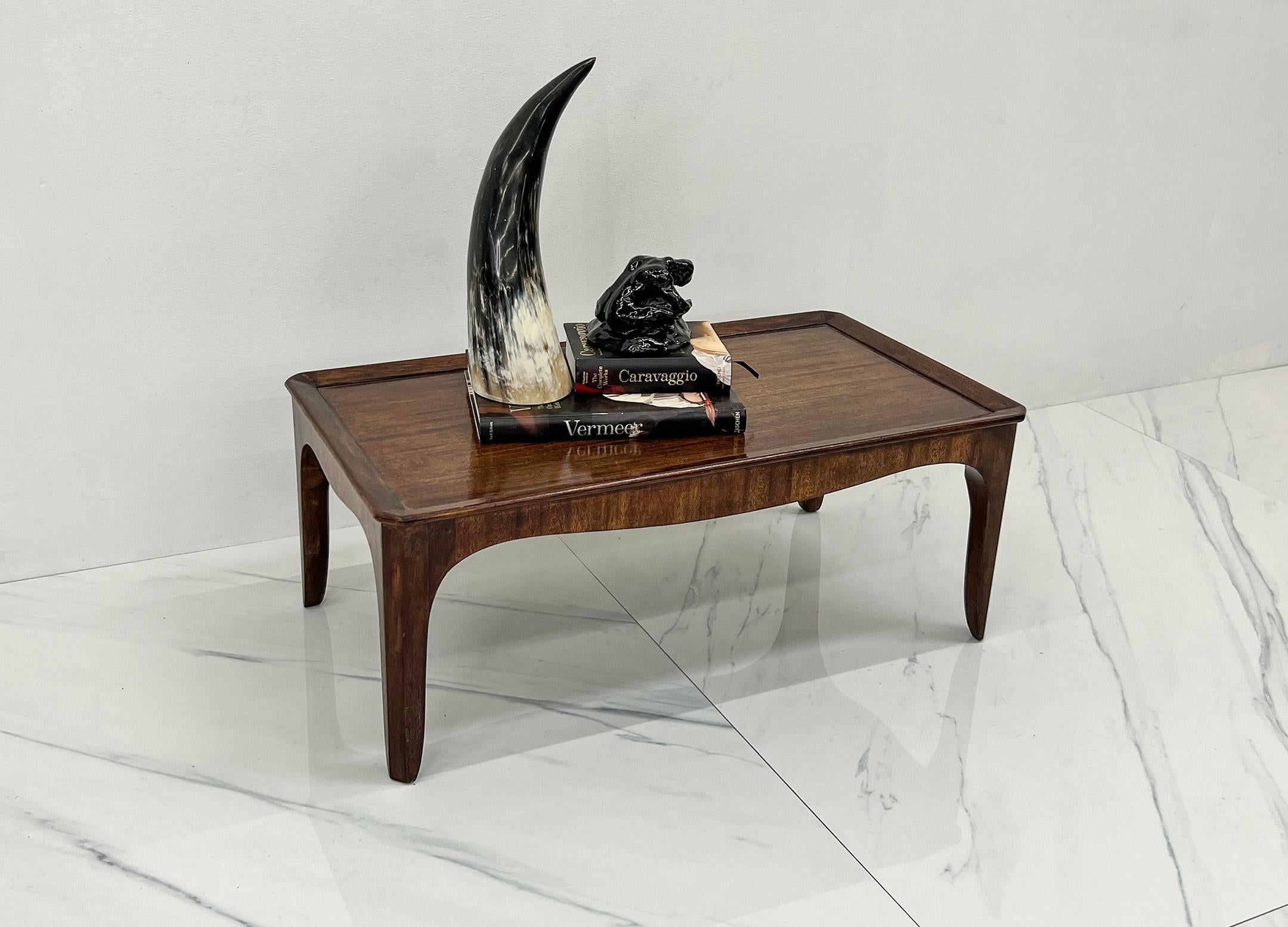 Nestled within the exquisite realm of early mid-century modern design, this diminutive Edward Wormley coffee table for Dunbar Furniture emerges as a timeless masterpiece. Crafted from solid mahogany, this petite gem encapsulates the essence of