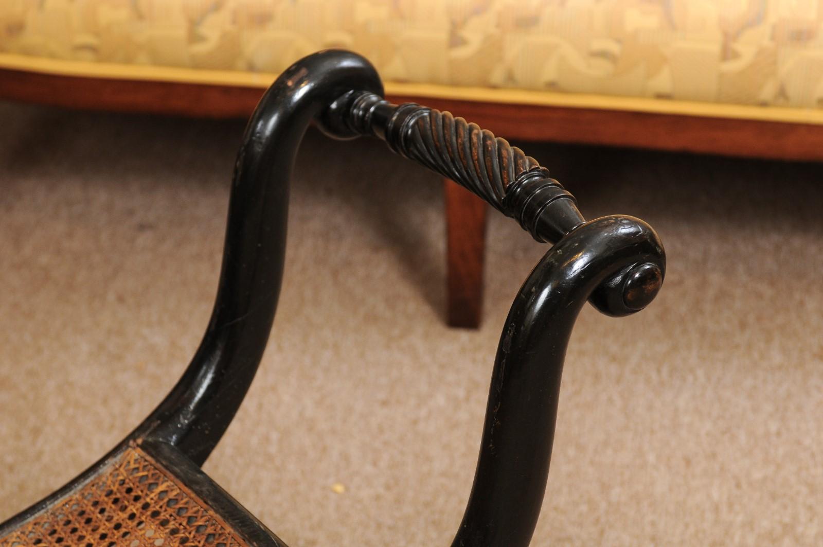 Wood Early Regency English Ebonized and Caned Elongated Curule Stool, circa 1810