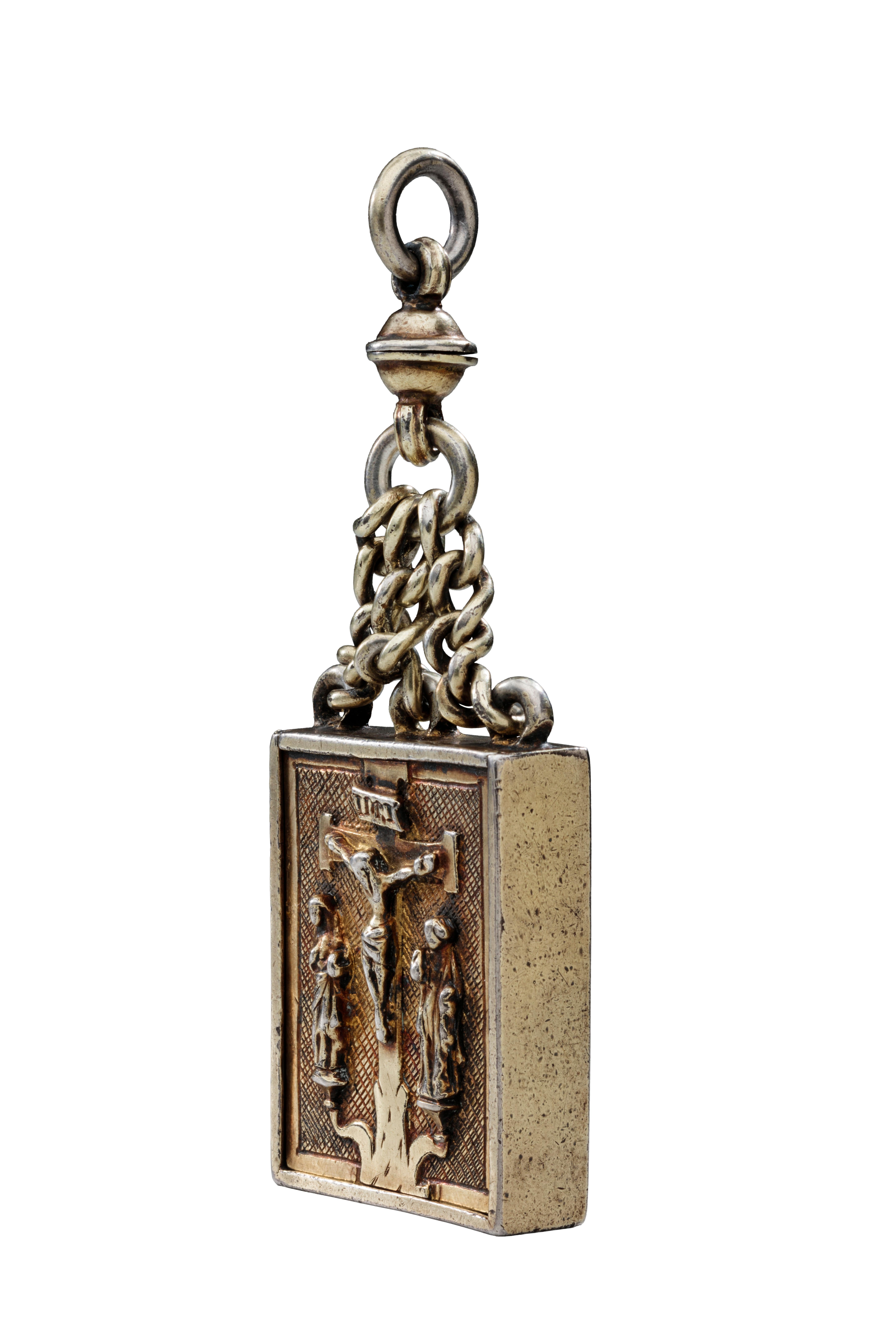 Reliquary Pendant with Crucifixion
Germany, 1450–1500 
Gilded silver 
Weight 88.3 grams; dimensions 102 × 39 × 11 mm (with chain), 46 × 39 × 11 mm (without chain) 

Gilded silver reliquary pendant comprising a flat rectangular box with plain sides