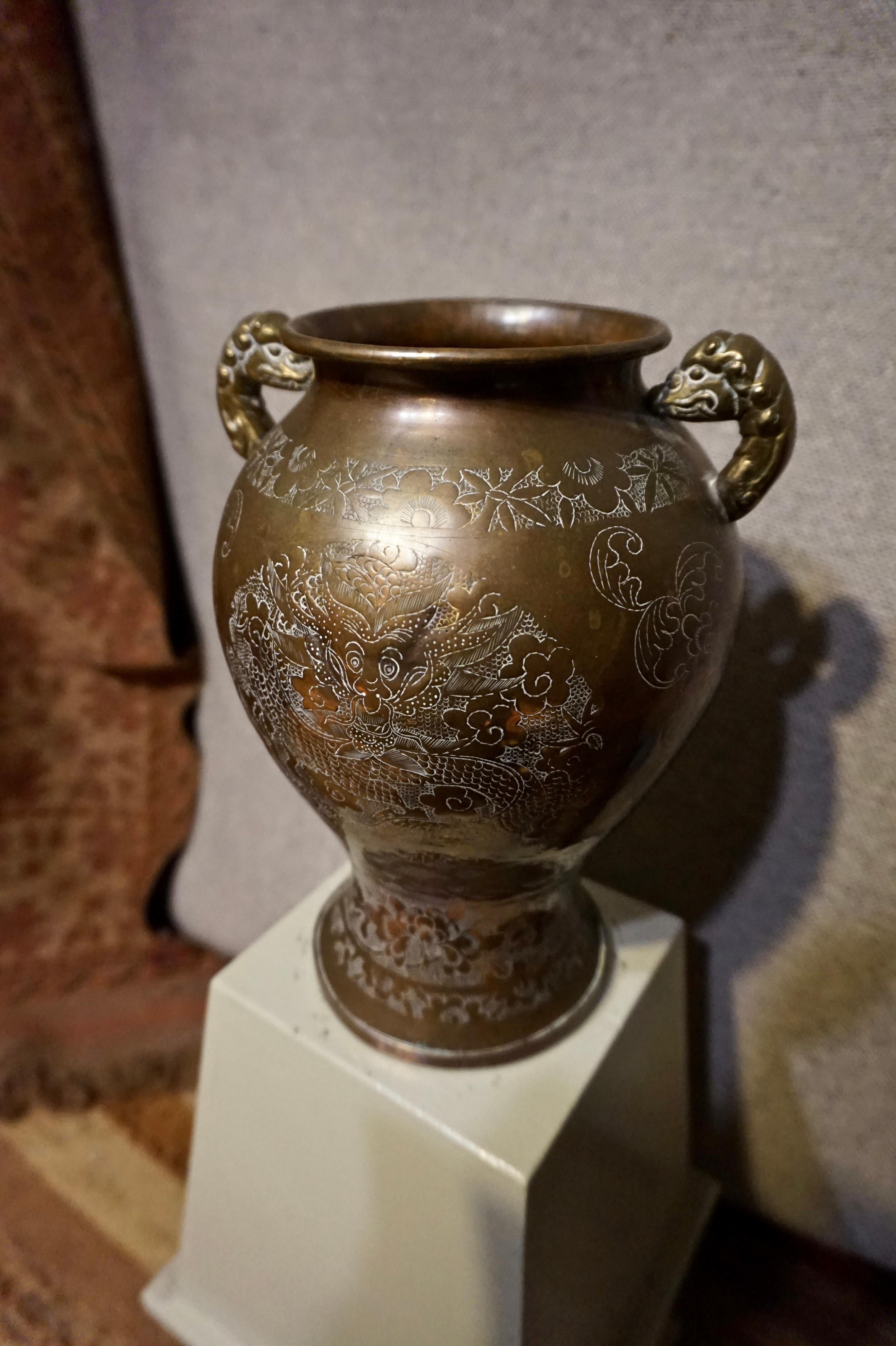 Circa 1900
Auspicious symbolism rendered in fine detail. Original patina and good form with serpentine dragon handles.
