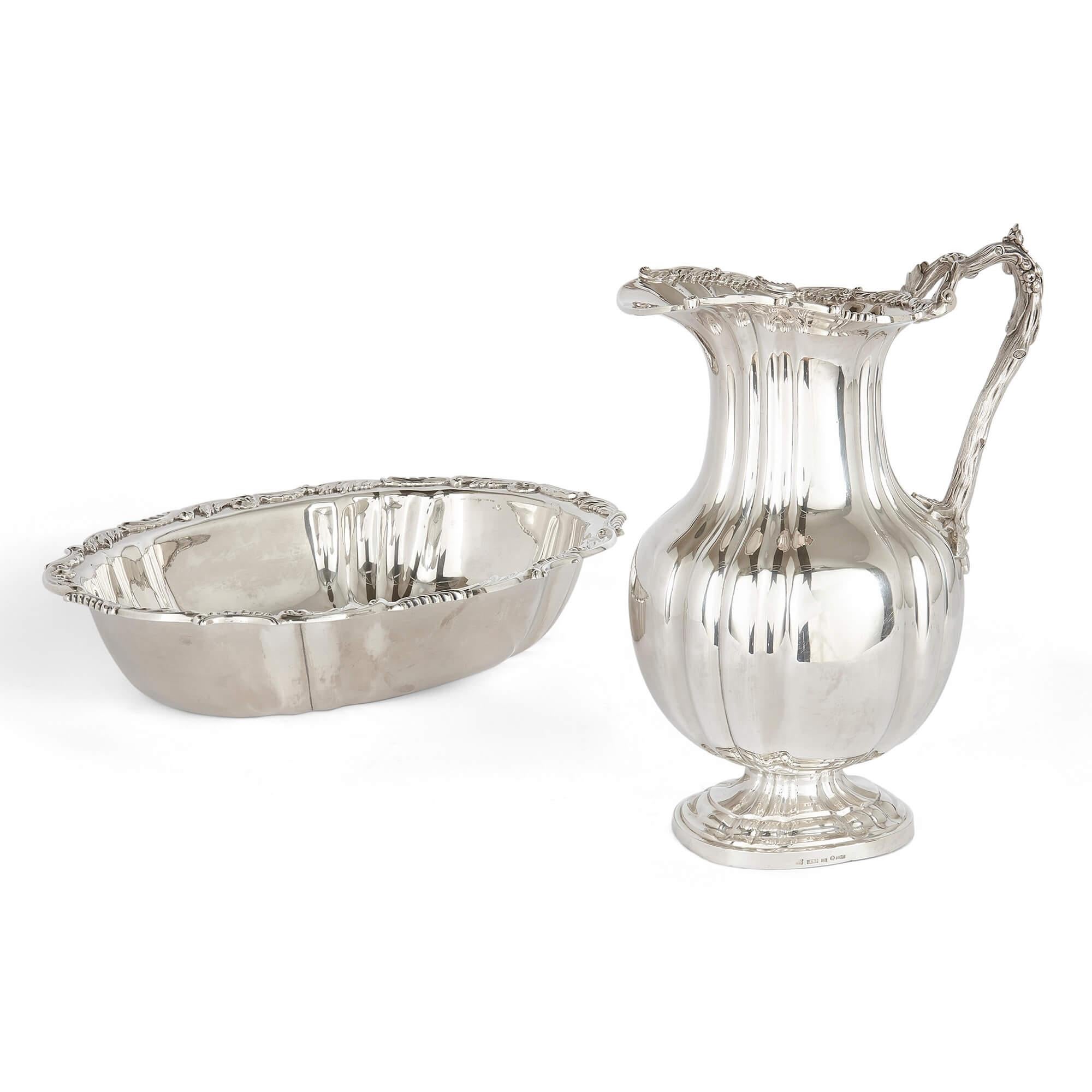 Early Russian silver ewer and basin set by Lang
Russian, 1838-9
Jug: Height 9cm, width 21cm, depth 15cm 
Basin:  Height 8cm, width 39cm, depth 29.5cm

Emerging from the early 19th Century Nicholas I era, this exceptional pair of a basin and ewer, is