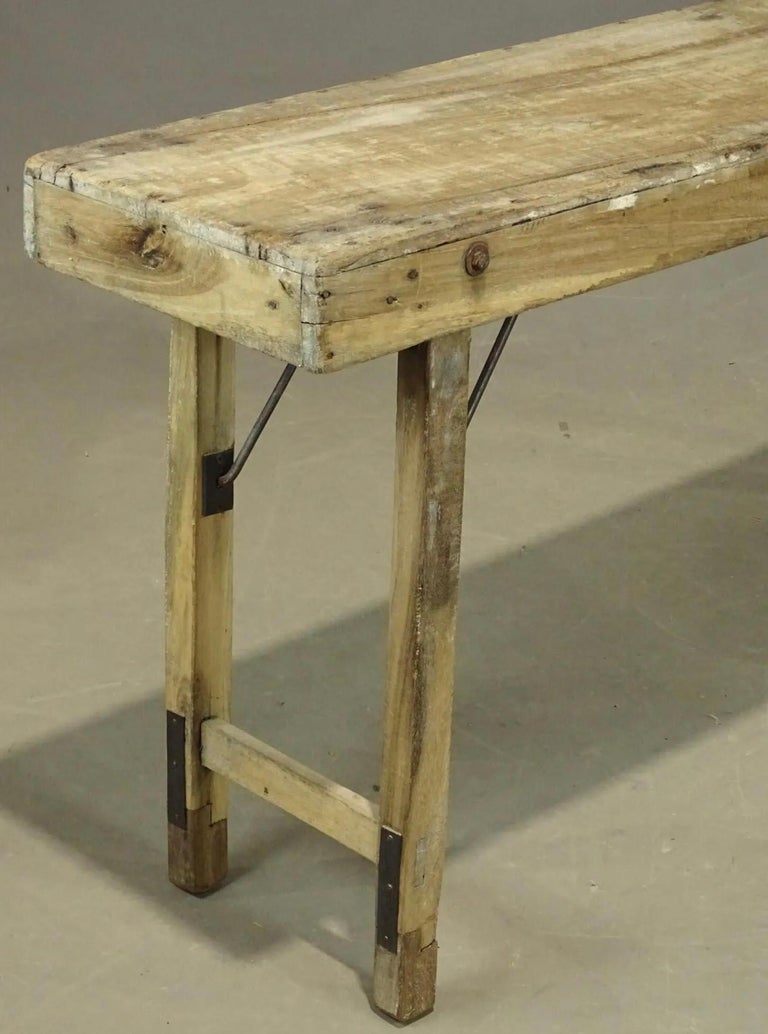 An early rustic folding table used by tradesman possibly for paper hanging. Table folds up making it easy to transport to projects. 
Use this table for a console table, sofa table, worktable or serving table.