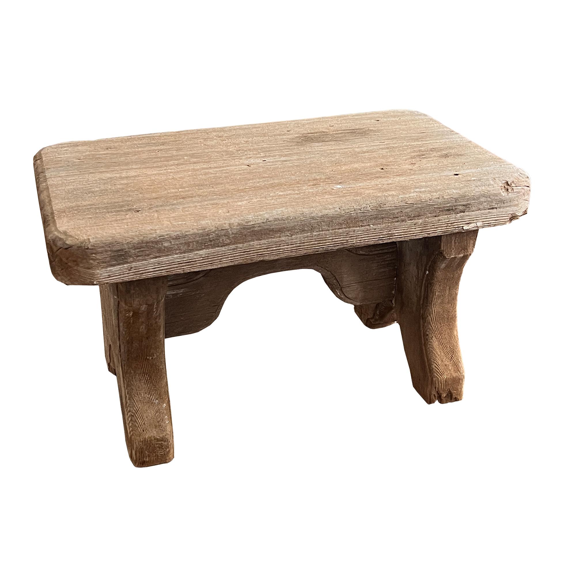A beautifully timeworn early rustic wooden stool, handcrafted from solid pine with charming primitive joinery and thick, sculptural legs. Likely dating to the early 20th century or late 19th century, this humble yet soulful piece is a testament to