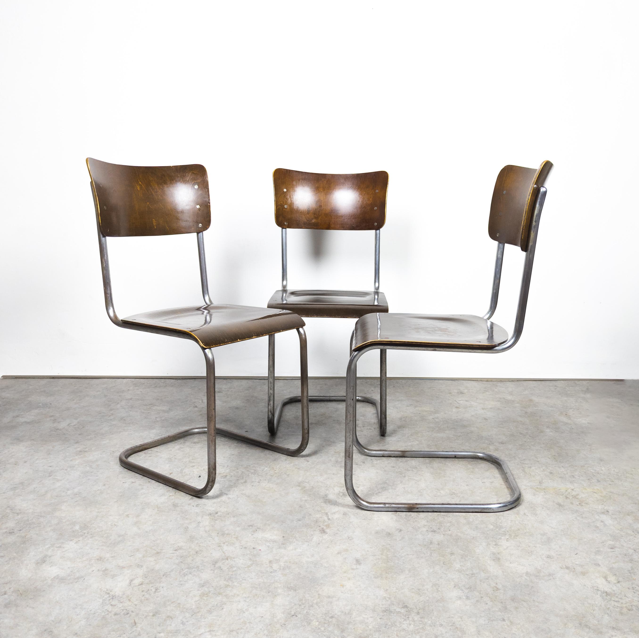 Rare early chairs manufactured by Vichr & co. , former Czechoslovakia in the 1930s. Set of three Bauhaus cantilever chairs with a sturdy tubular steel frame, showcasing vintage charm. The steel elements exhibit distinct signs of aging, while the