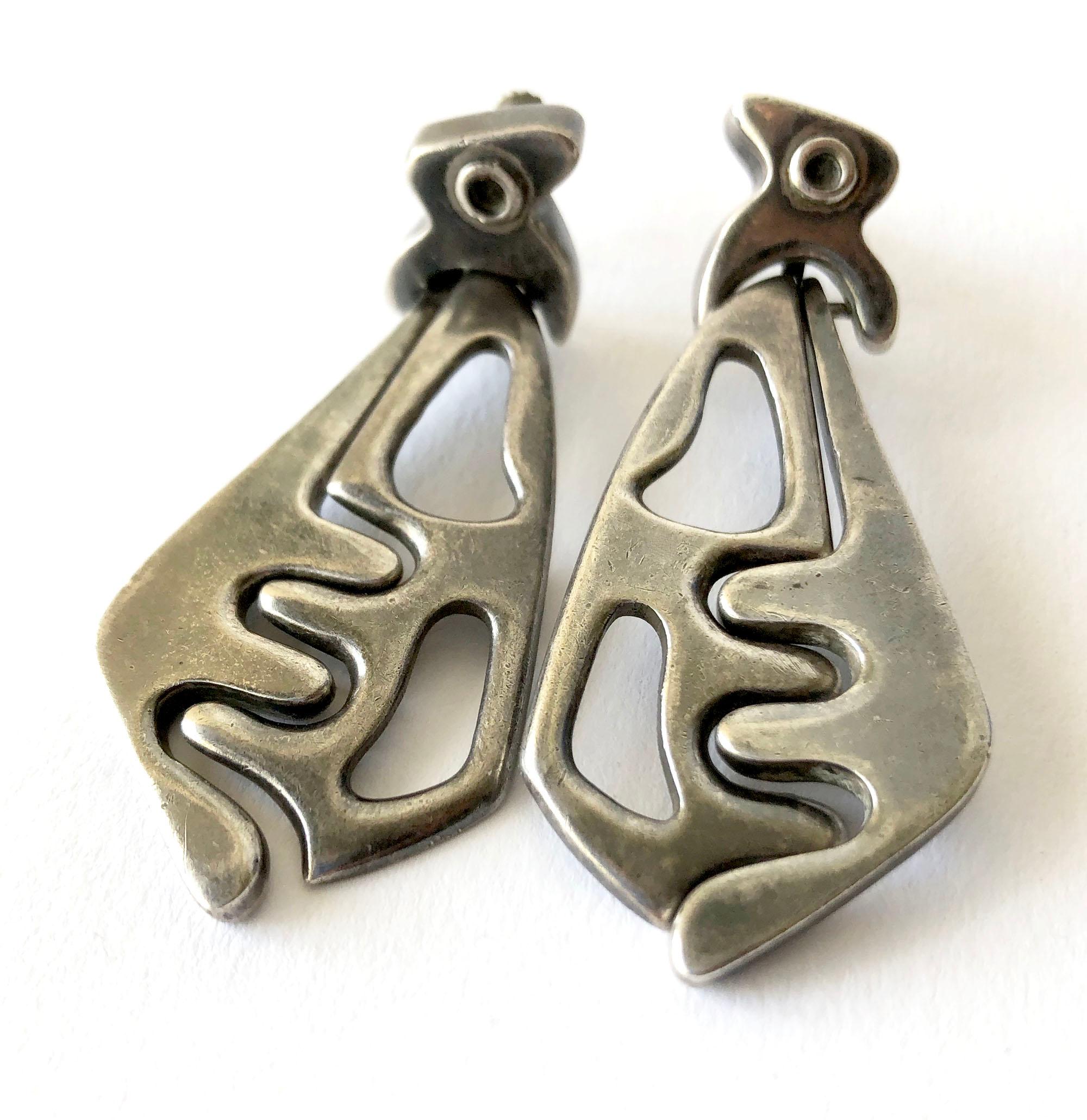 Sterling silver Mexican modernist dangling earrings created by Salvador Teran of Mexico.  Earrings are of the screwback variety and signed with his early shop marks, hallmark and Taller Mexico, 121.  Earrings measure 2.5