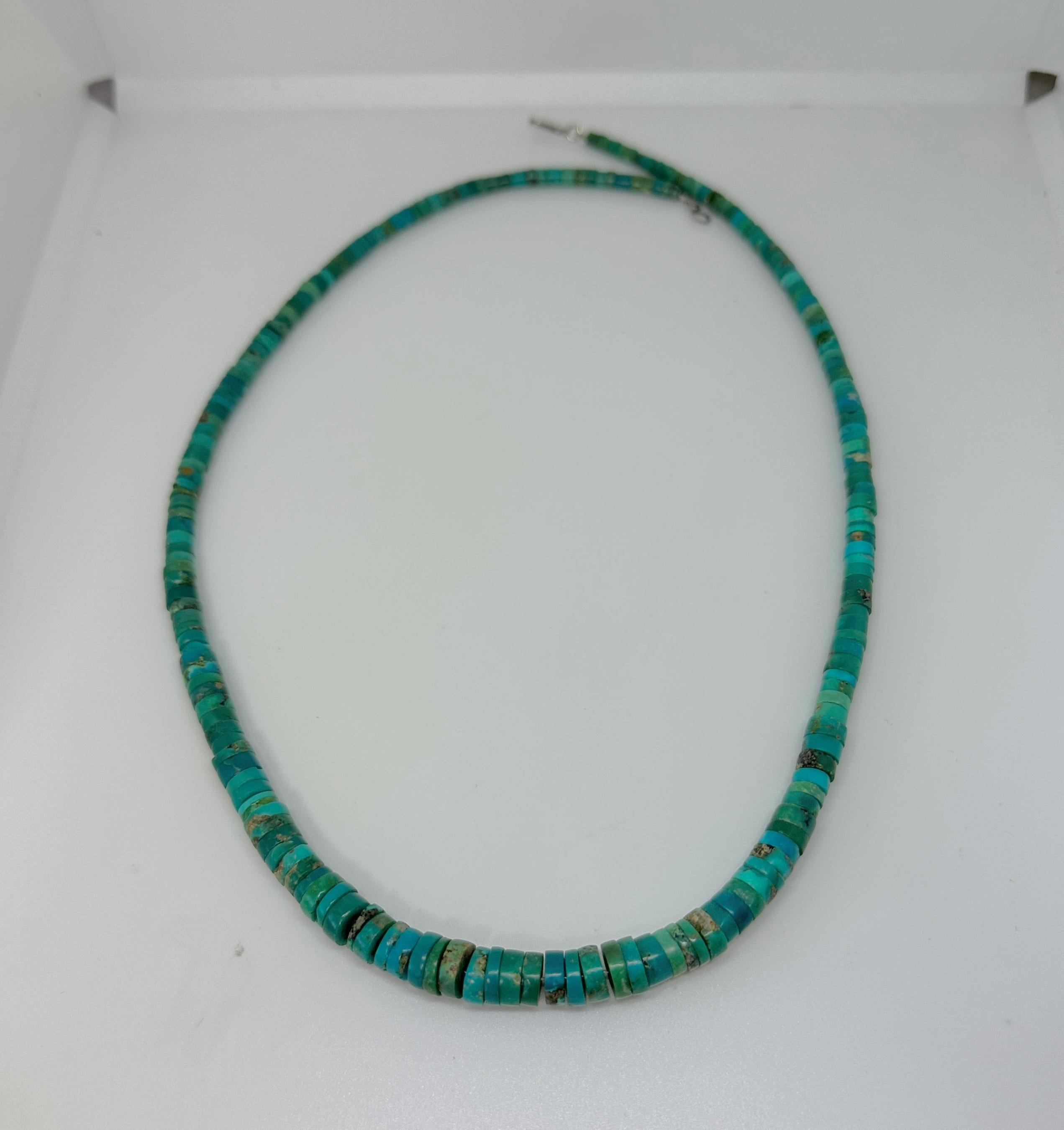 This is a stunning Native American 1920s Caribbean Blue and Green Turquoise Heishi Bead Necklace of 21 inches in length. 
The magnificent hand cut Turquoise Heishi Beads are graduated from 4 to 8mm in diameter. The necklace is fabulous piece of