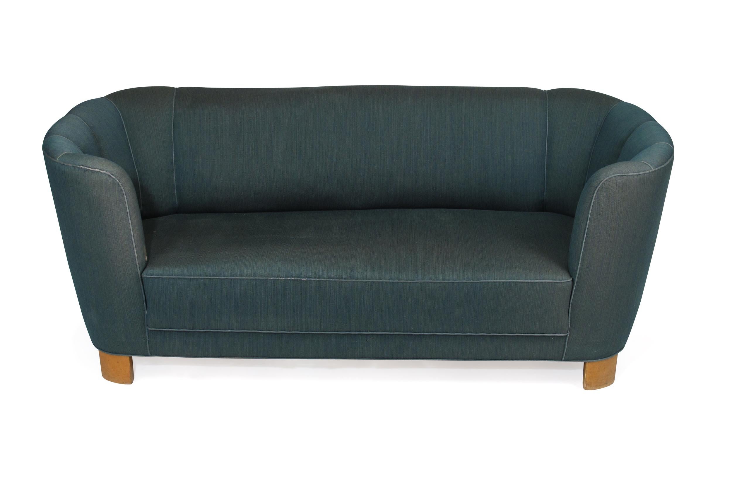 1940s Danish curved back sofa in original blue fabric for reupholstery. Solid wood structure with eight-way hand-tied springs in seat.