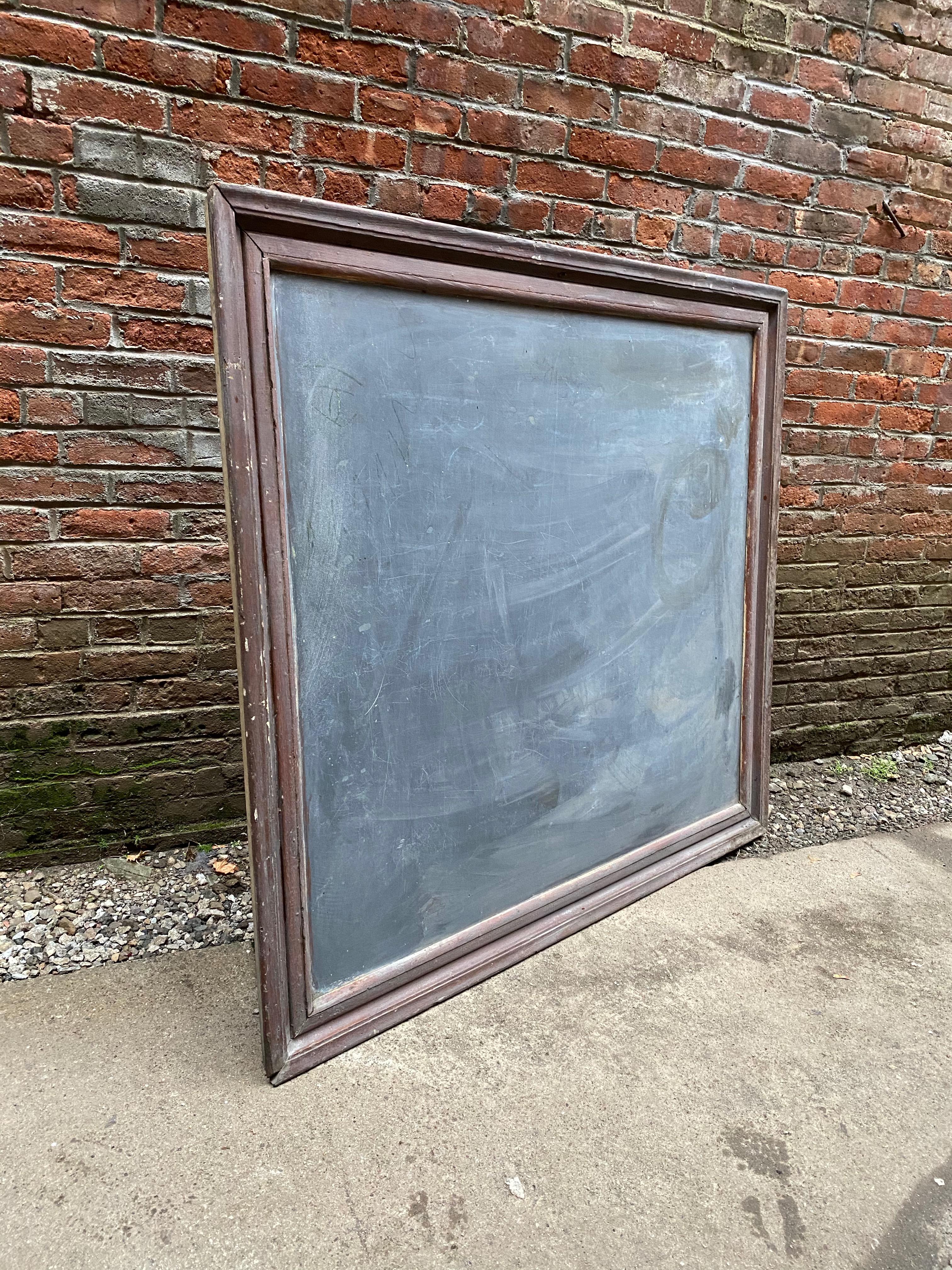 Large and impressive thick slate school house chalkboard. Distressed and painted wood frame. This single piece of slate measures around .50