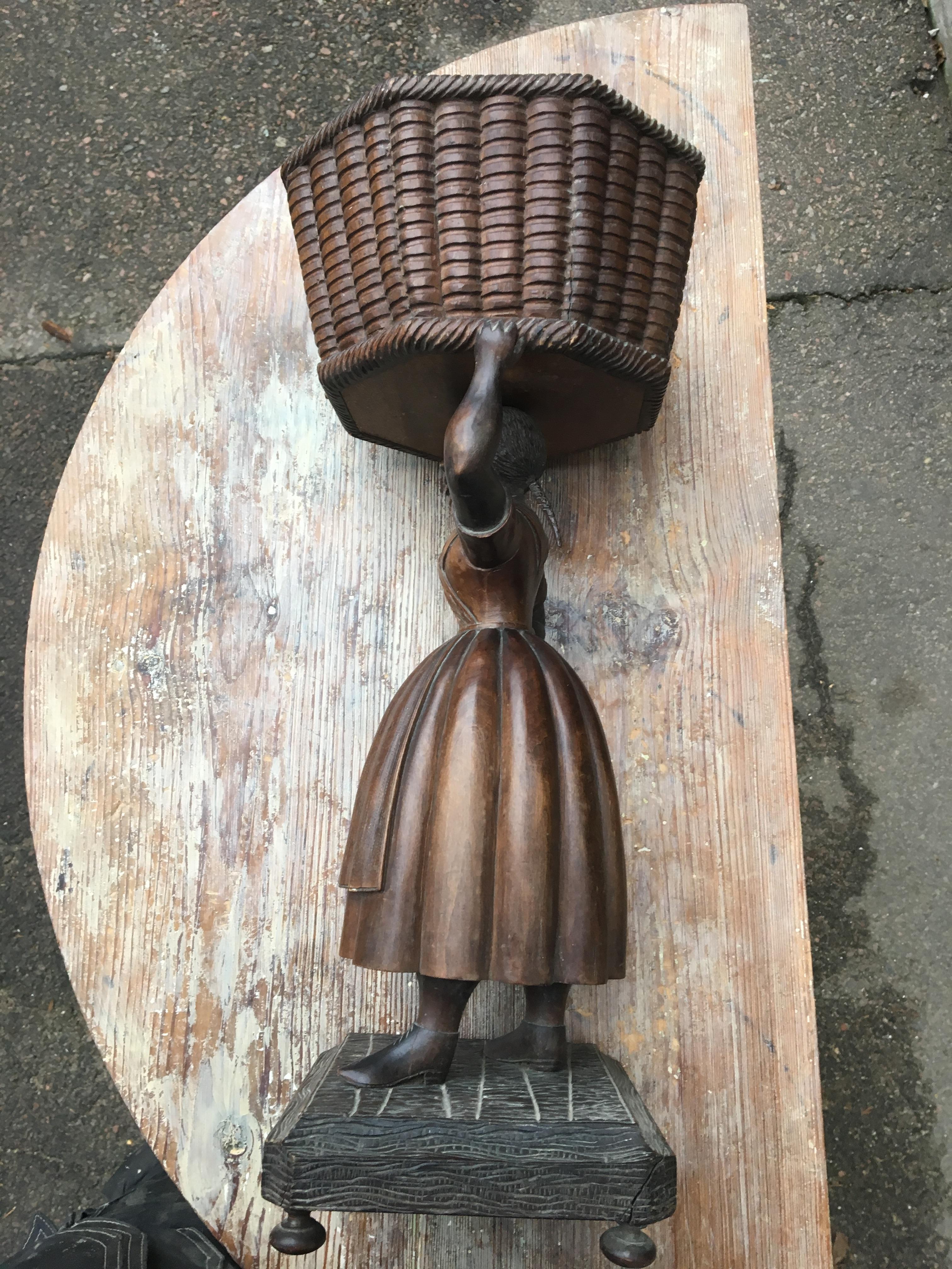 Early 20th Century sculpture of basket-carrying Lady