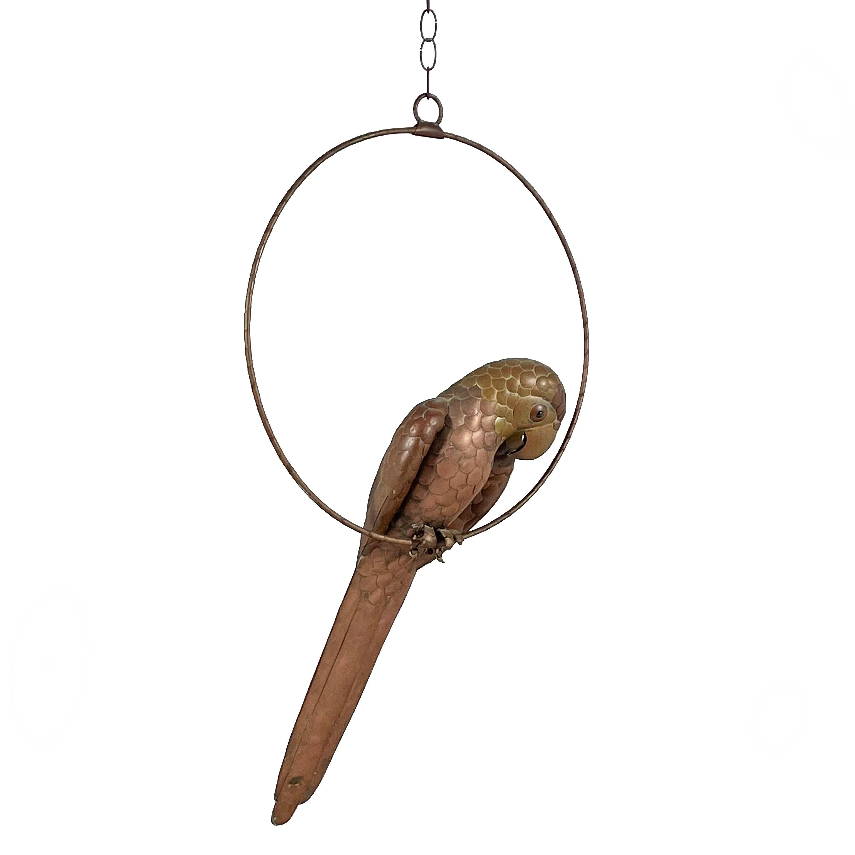 Bustamante's playful animals are imbued with character regardless of the materials they are made with. This parrot in copper and brass makes the perfect companion sitting on his perch surveying his surroundings. Beautifully detailed and having