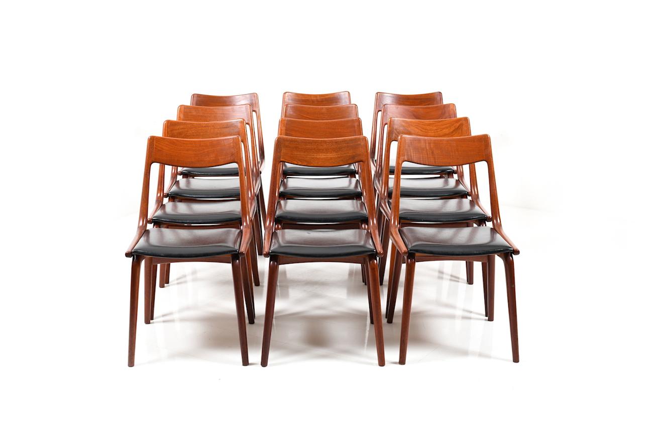 Set of 12 dining chairs in solid teak by Alfred Christensen. Model no.370 'Boomerang'. Seats in original black imitation leather. Produced by Slagelse Møbelværk, early 1950s. This set was one of first productions!