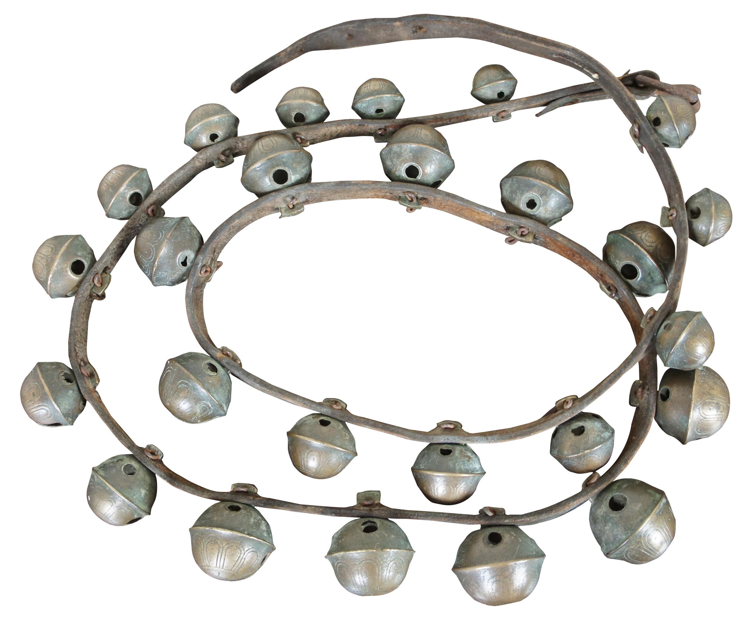 Antique set of graduated brass sleigh bells mounted on a leather belt, ranging from small to large to small again along the length of the belt. Belt has two holes for size adjustment. Measure: 6 ft.

Adjustable length - 67.5” / 69”.