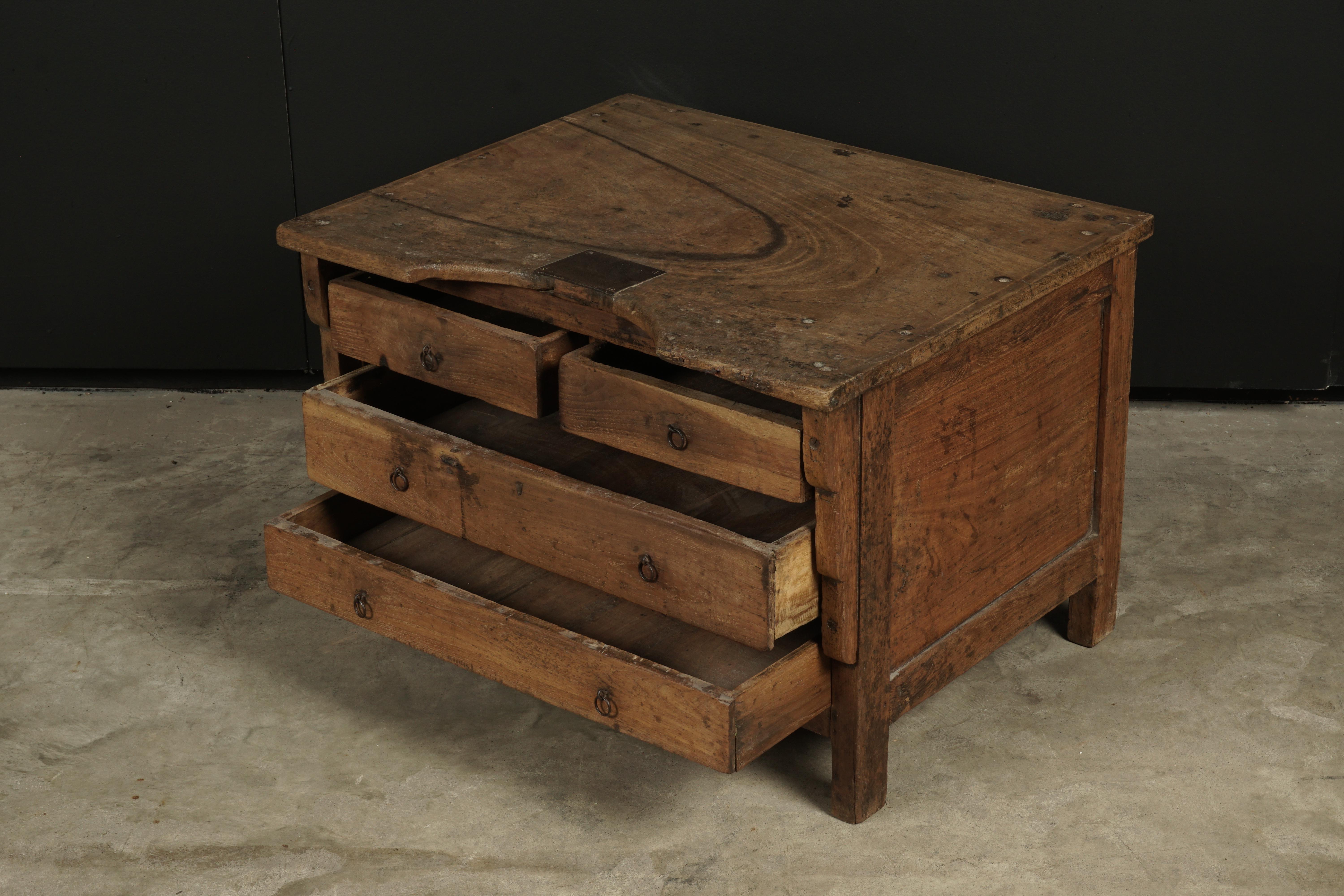 Early jeweler's table from France, circa 1900. Four small drawers for storage. Solid walnut and oak construction. Great patina and wear.