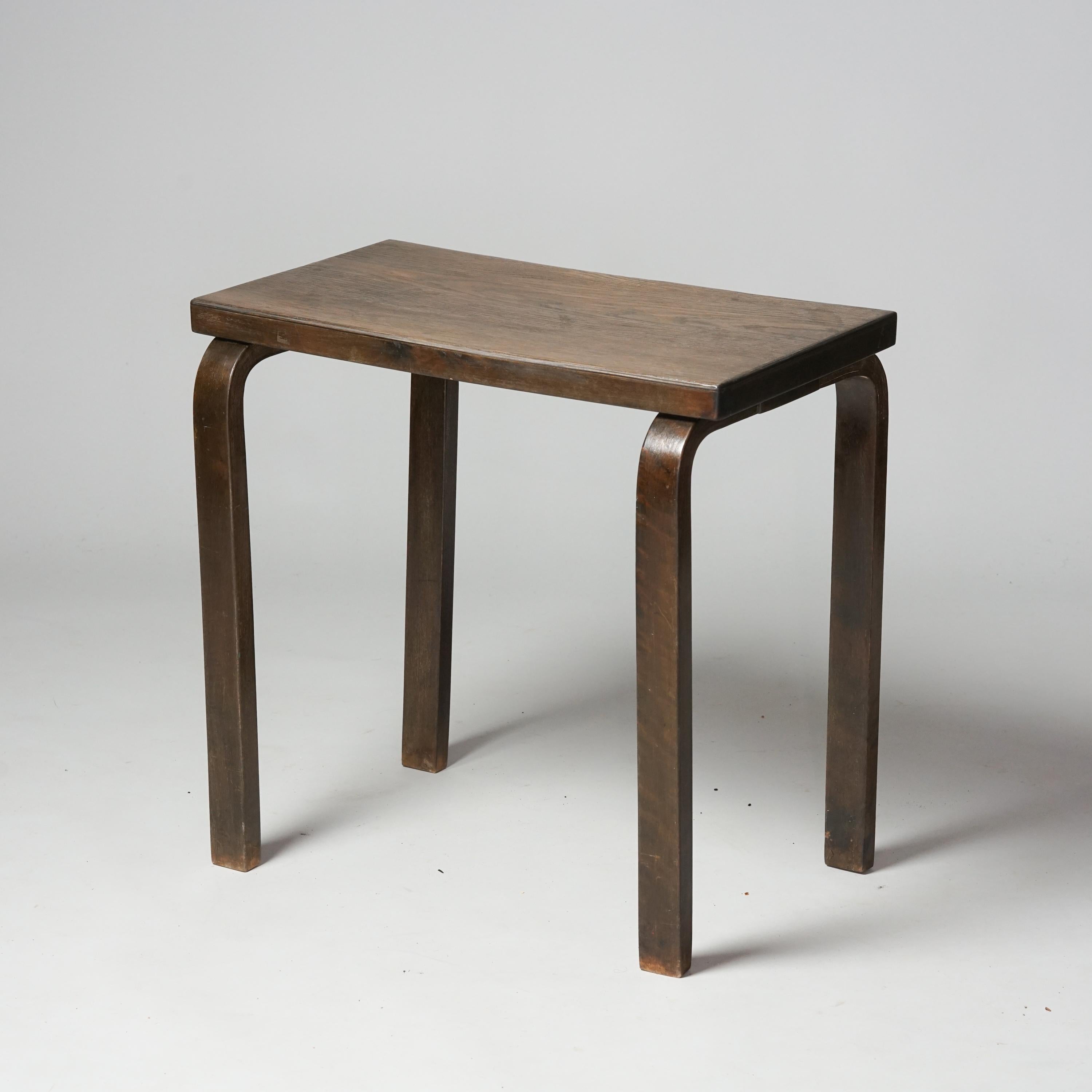 Side table, designed by Alvar Aalto, manufactured by Oy Huonekalu- ja Rakennustyötehdas Ab, 1930s. Stained birch frame with oak veneer table top. Good vintage condition, minor patina consistent with age and use. 

Alvar Aalto (1898-1976) is probably