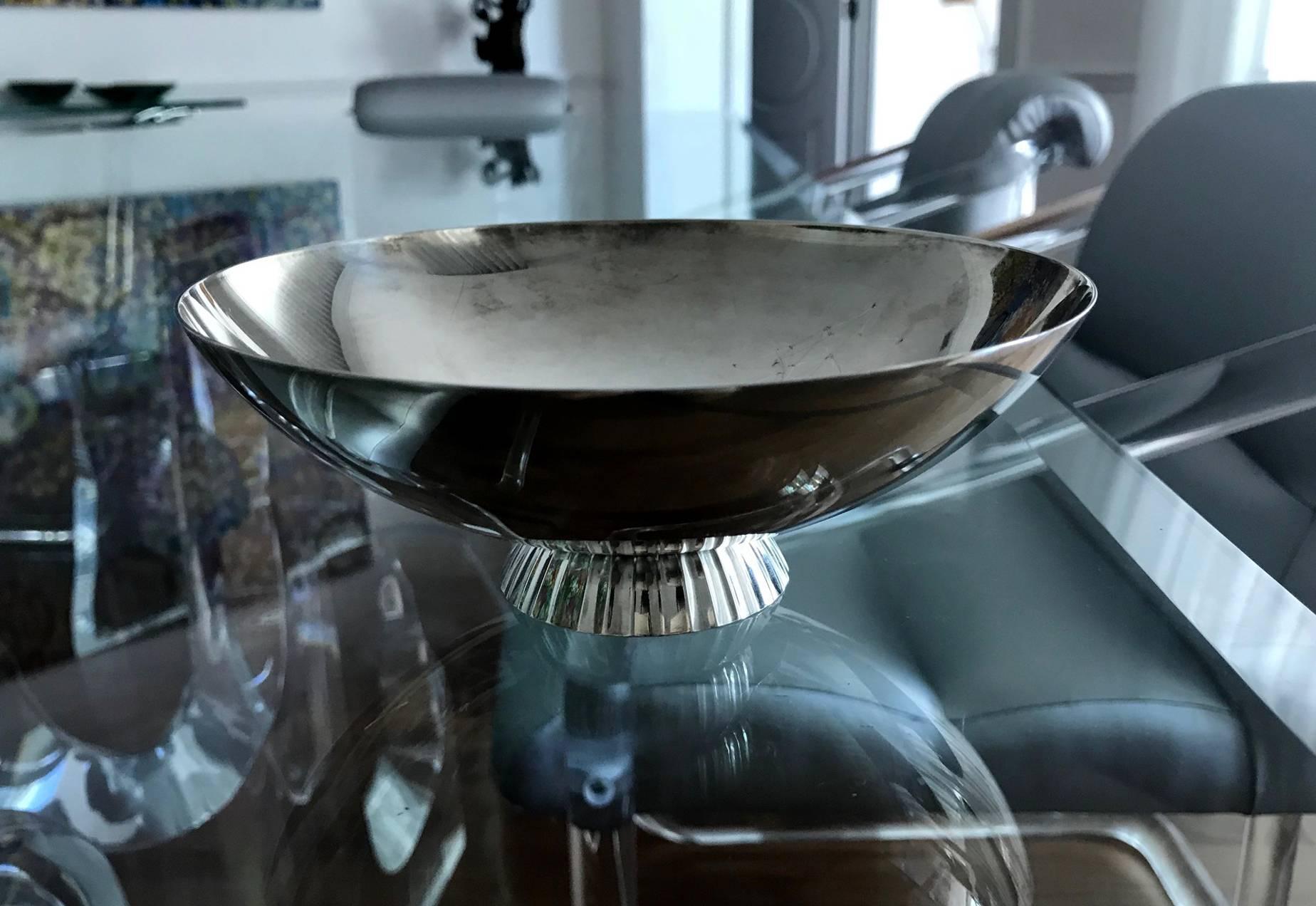 A Danish sterling silver bowl with double-walled fluted foot, model #823. Early Georg Jensen production with mark dated to 1933-1944. Designed by Sigvard Bernadotte (1907-2002), marked on underside for maker and designer; Elegant form. wt. 8.34ozt.