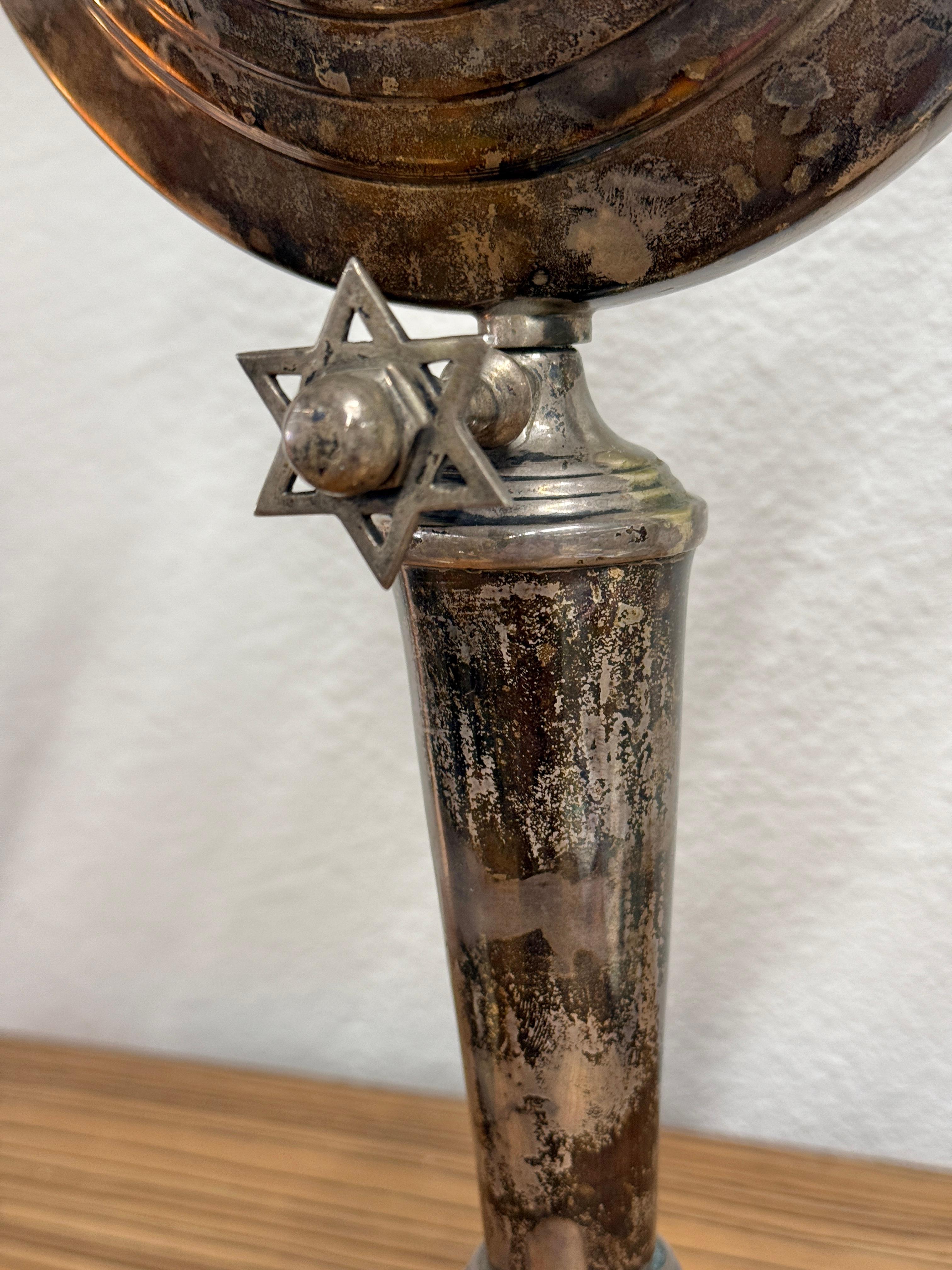 A nice early 20th century silver plated Menorah. In estate found condition, we have not tried to polish it. Nice patina. 
No markings at all, but assumed to be silver plated and European. 
In good overall condition although a couple of the cups have