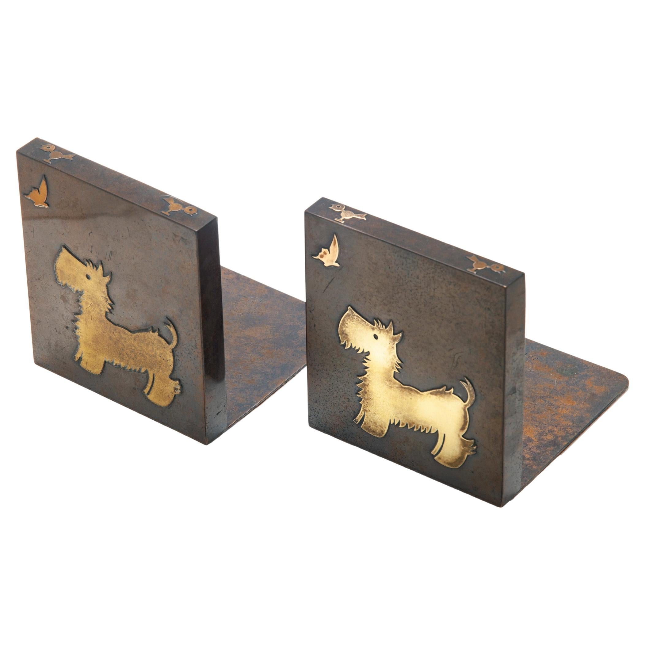 Early Silvercrest Bronze & Brazed Brass Scotty Bookends with Walnut Back, set/2
These Scotty or Westie Bookends are in bronze with brazed brass pups, whose attention is captivated by a butterfly. 
A tiny bird graces the top.
This precious image is