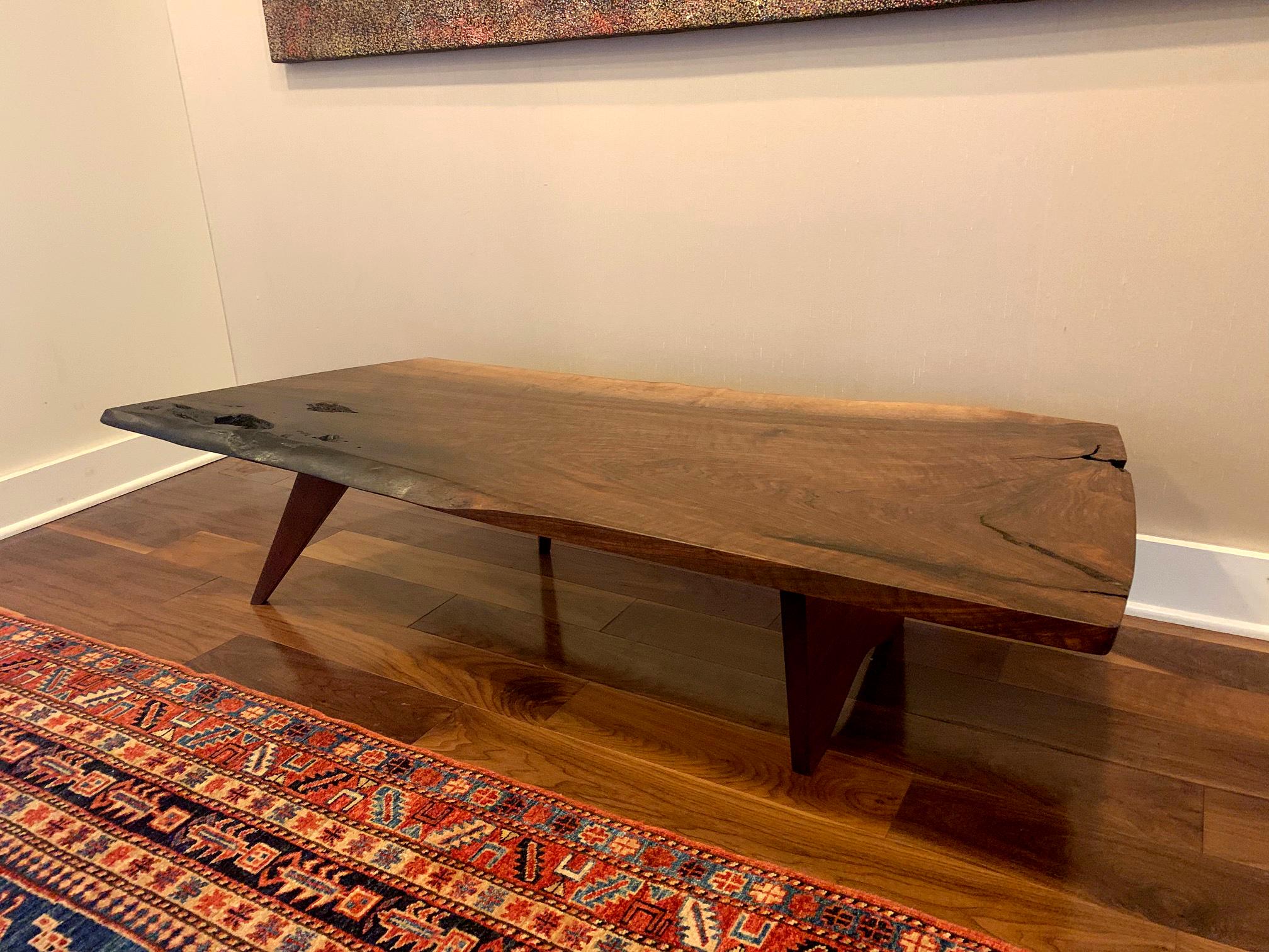 A stunning piece of furniture art by George Nakashima (1905-1990) from his early studio years circa 1958. It features a selected American walnut slab with amazing characters, finely crafted to showcase the design philosophy of George Nakashima: Let