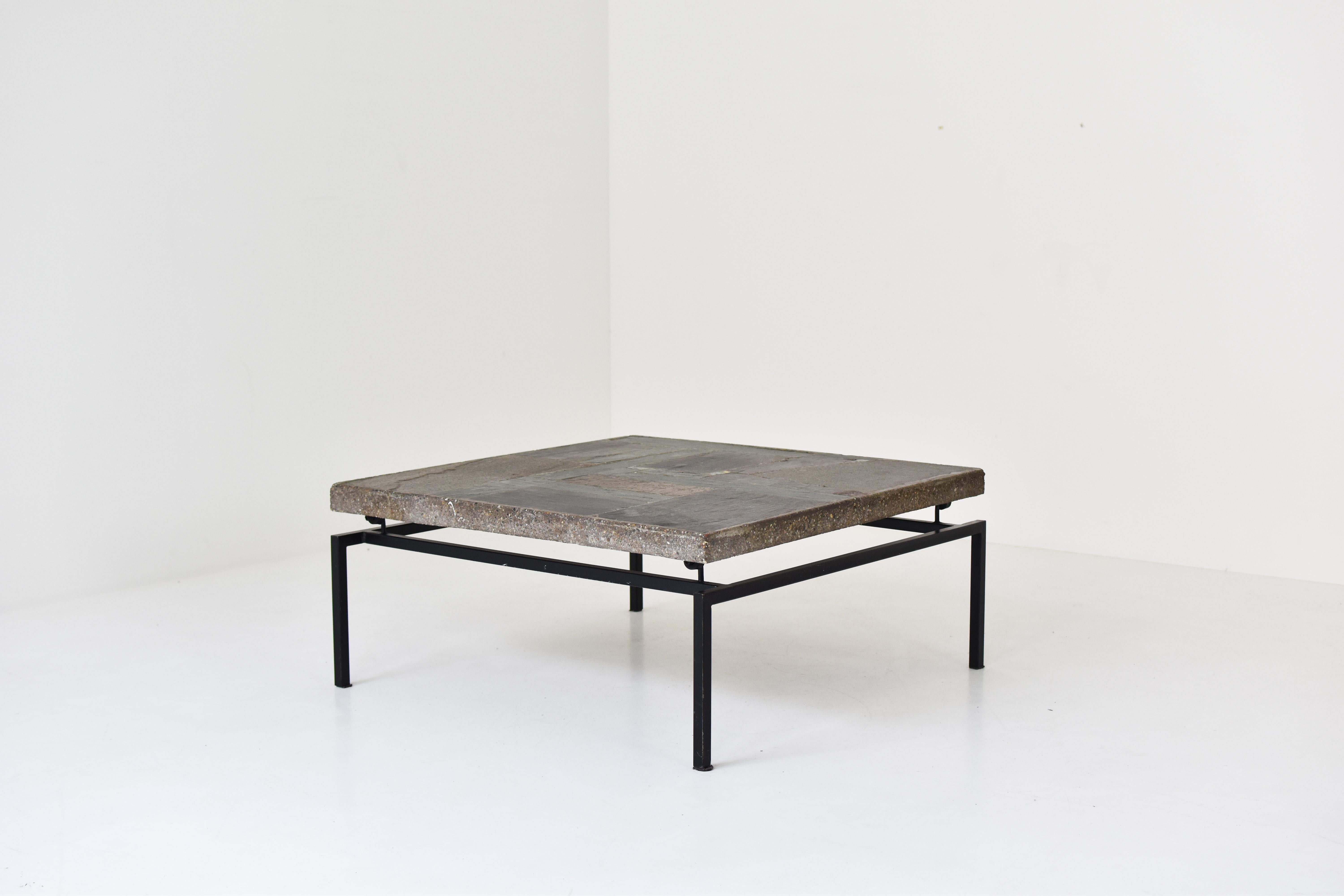 Early slate stone coffee table made by Paul Kingma and manufactured in his own atelier around Den Haag, The Netherlands 1960s. This square coffee table is a combination of ceramic and slate stone with copper inlays on a black lacquered metal base.
