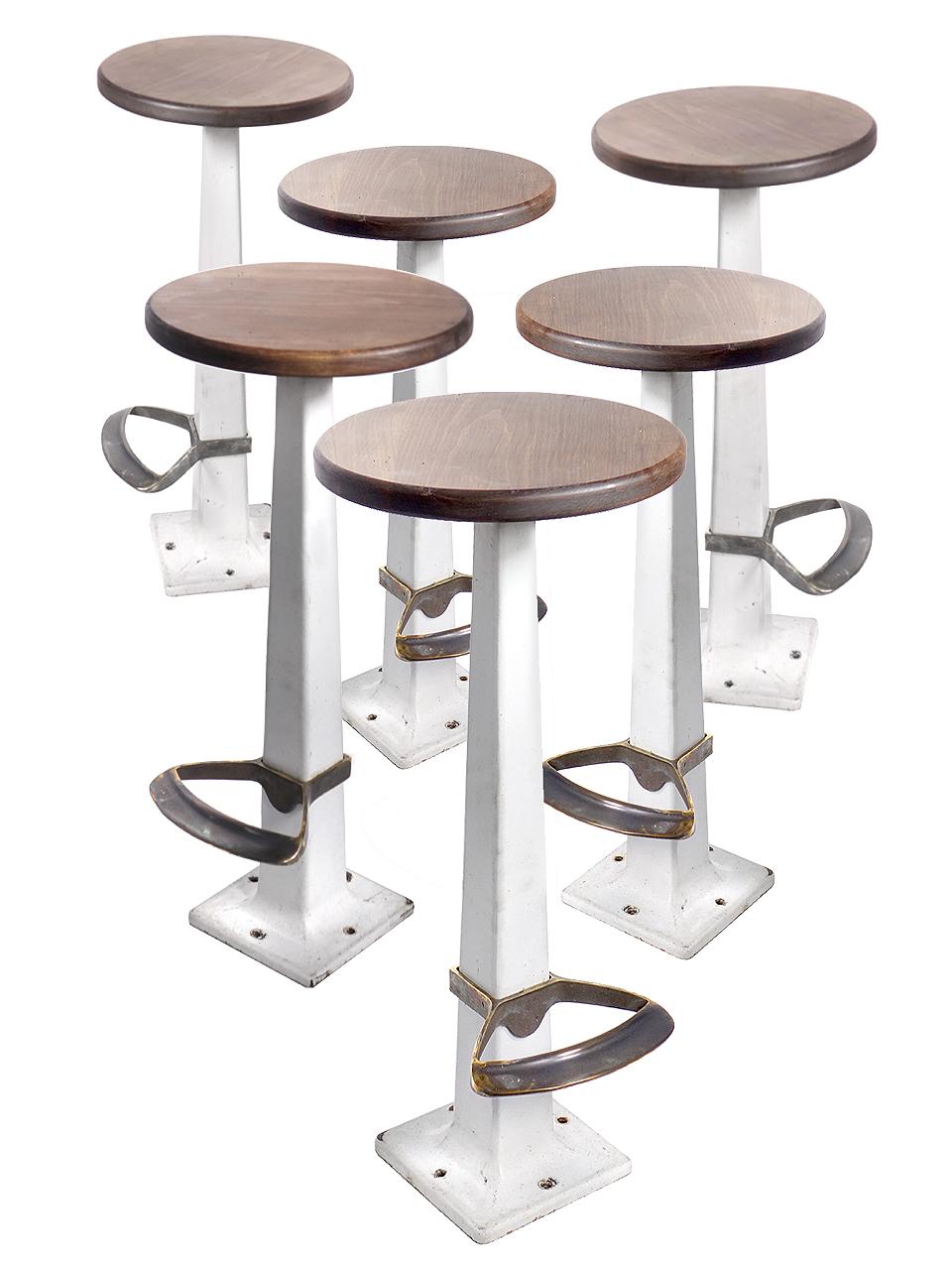 We have a collection of matching white porcelain counter stools. The bases show some age but each is too nice an original to refinish. They all have the rare slip on foot stools plus new Oak seats. They are sold as a set of six. All are signed on