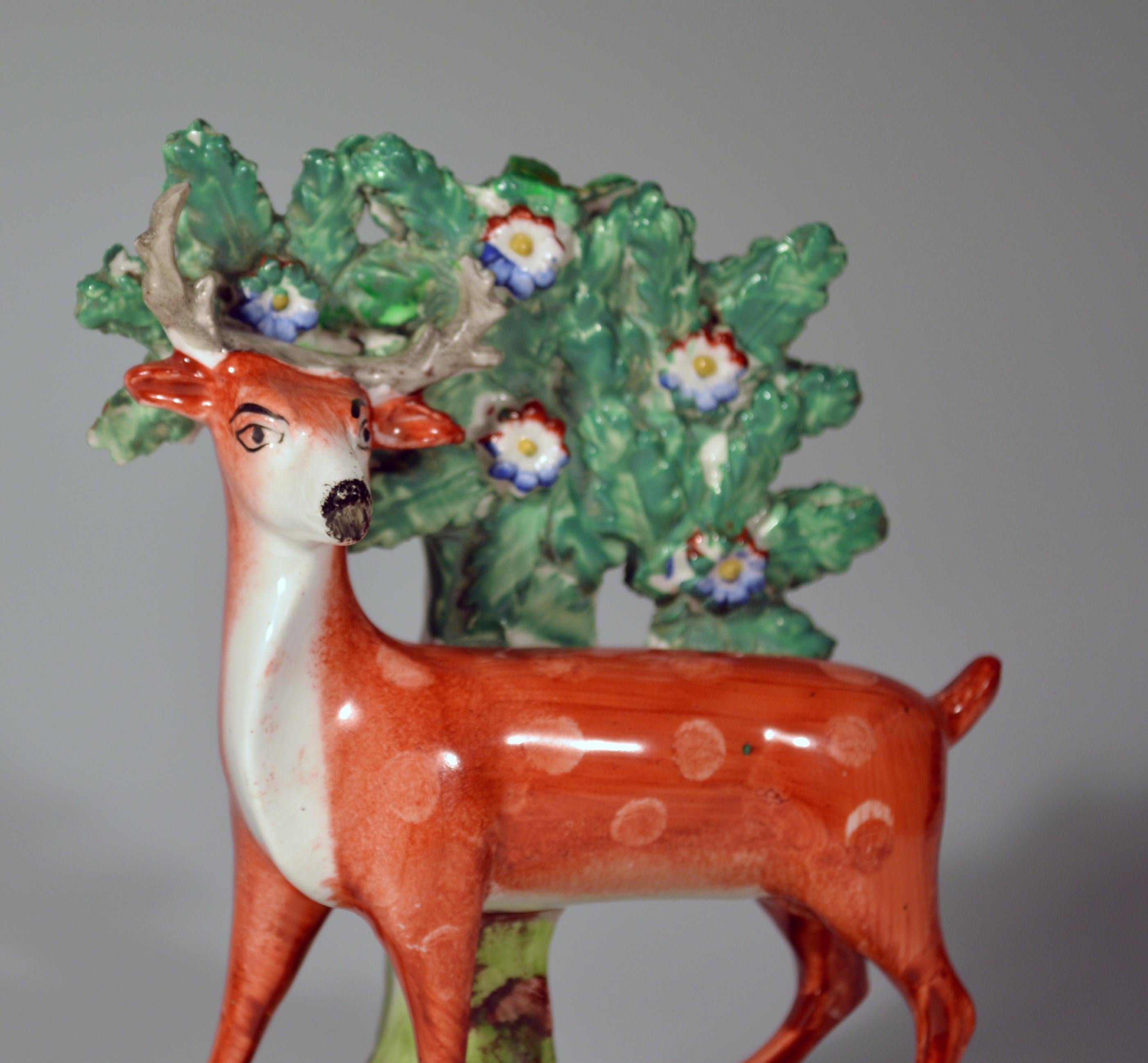 Early Staffordshire pearlware pair of deer Bocage figures, 
circa 1825.

The charming pair of bocage figures depict a spotted red stag and deer facing each other. They Stand with bocage behind and on a hollow mound base naturalistically coloured