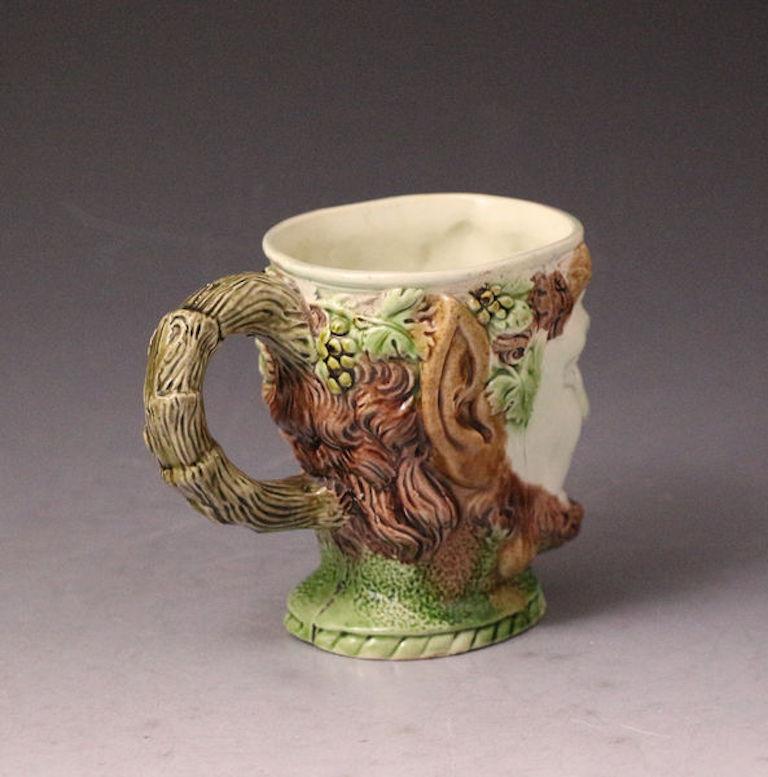 Early Staffordshire pottery ralph wood Bacchus tankard, late 18th century, England. The piece is in exceptionally fine order, an early example, crisp from the mold with high quality colored glazes. The best example of it type and a Classic from the