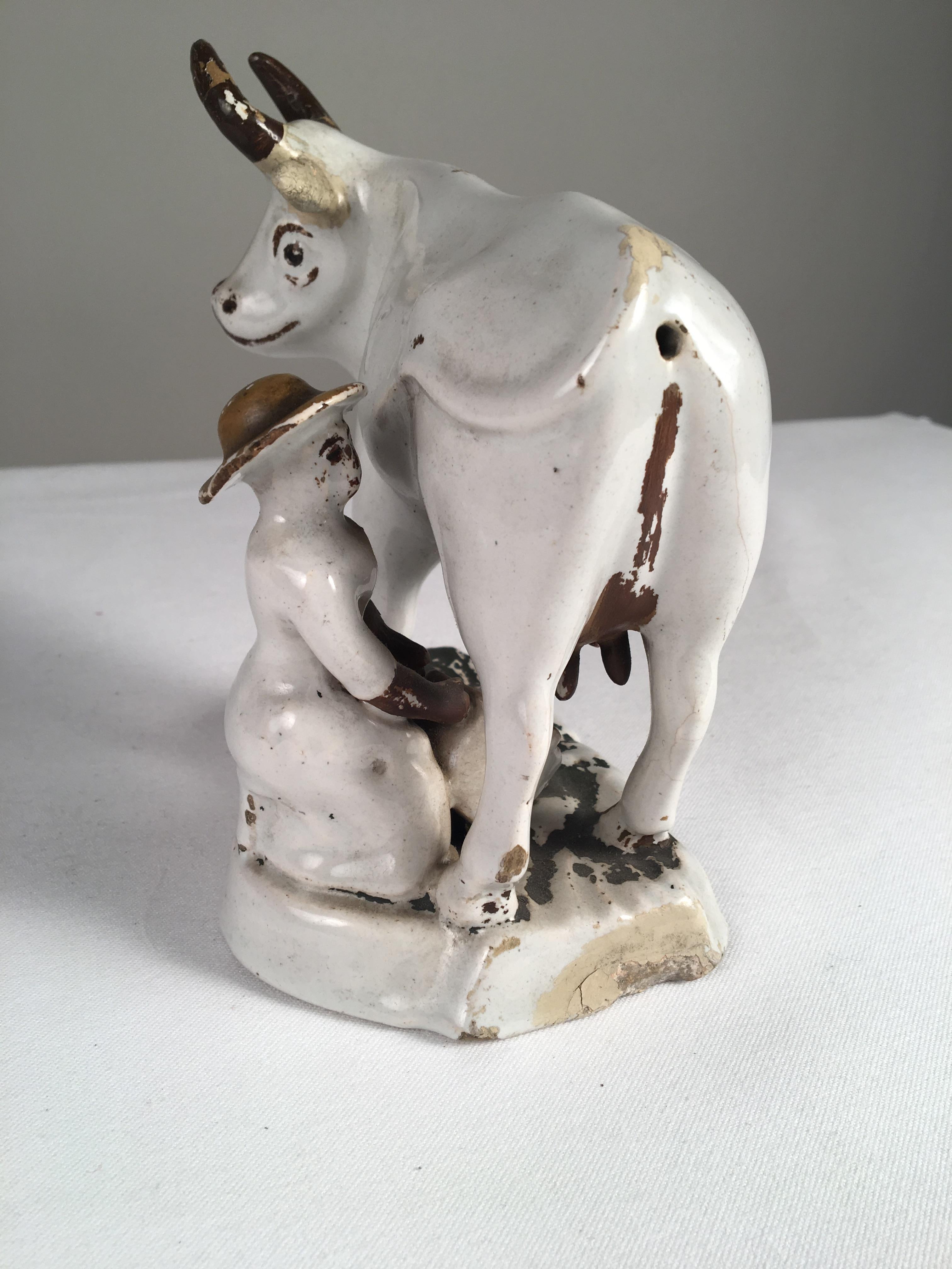 An unusual undecorated Staffordshire cow figurine, with painted details, early 19th century, English.