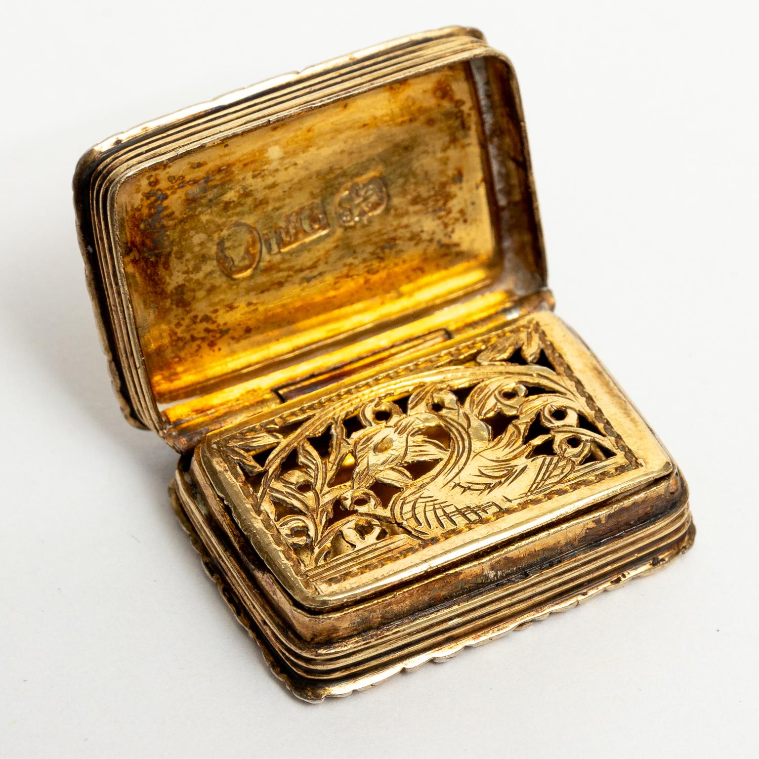 Circa early 19th century sterling silver vinaigrette box made in Birmingham, England. The interior is fitted with a small hinged screen decorated with a swan motif framed by scrolled foliage. This screen is used to securely enclose a small piece of