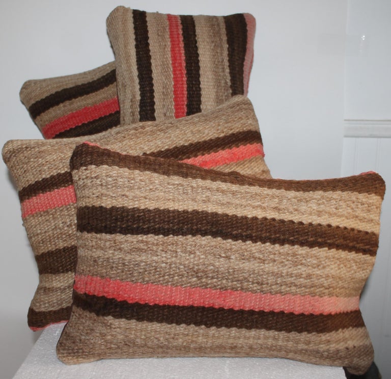 Early hand woven Navajo Indian weaving small pillows. We are selling these pillows as a collection of four. They were made from a very early late 19Thc saddle blanket.