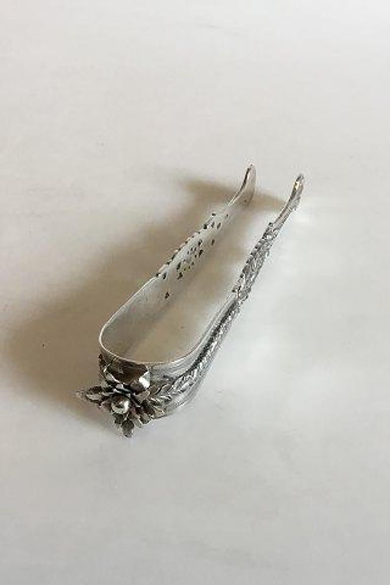 Early Sugar Tongs in silver plate or not pure early silver.

With dedication 