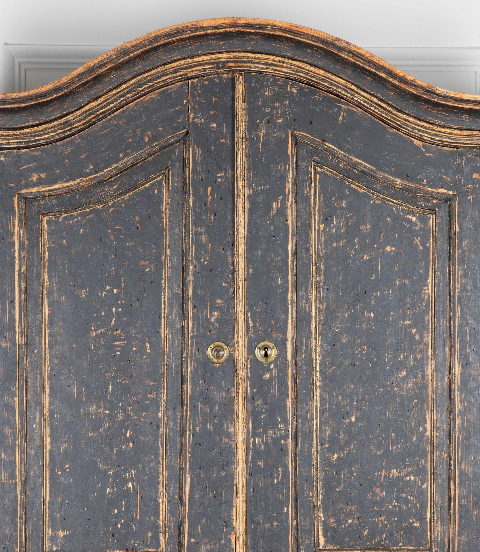 Early 19th Century Rococo secretary.

With a decorative carved pediment with two doors opening to storage. With a fall front desk opening to writing space.

With drawers below two short and two long drawers. Repainted in soft black with a green