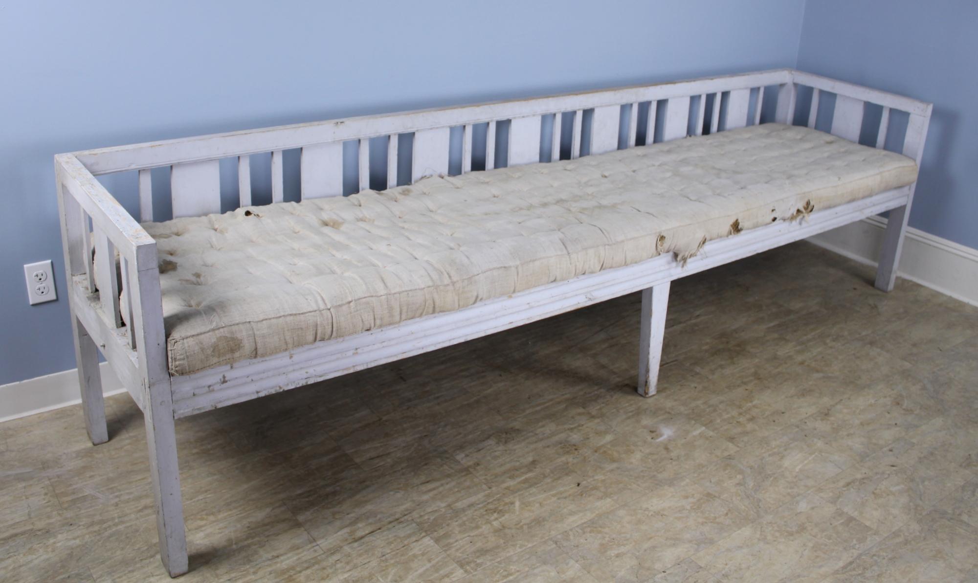 We don't see this kind of piece often. Quite early with exceptional proportions - almost 9.5 feet long with original paint and horse hair stuffed cushion, ready for reupholstery. This piece is very sturdy and resplendent with rustic charm. Has been