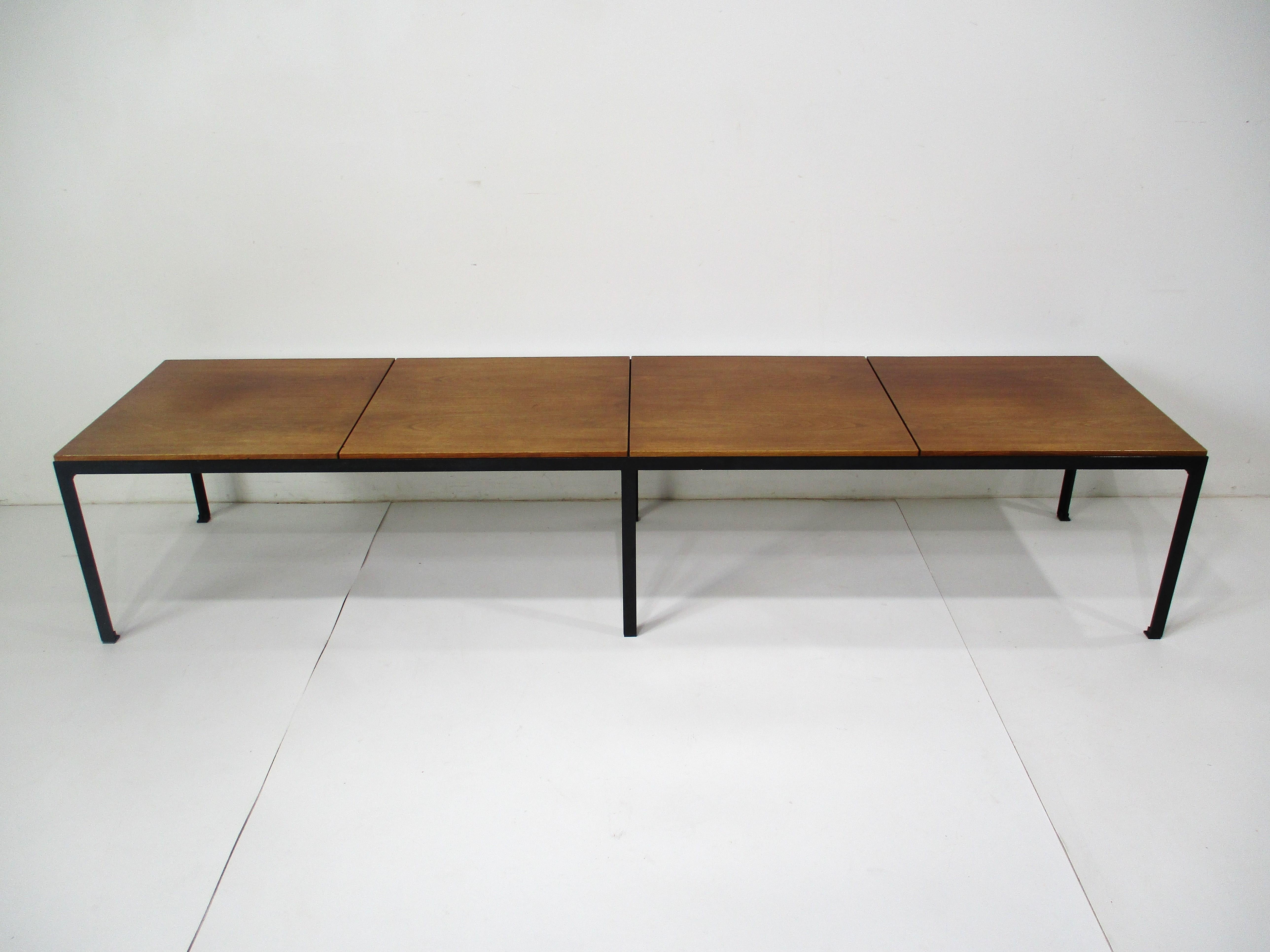 A very early and rare segmented topped walnut coffee table or bench with satin black T angled metal base . This architectural styled piece would fit into almost any interior room or entrance way with it's well crafted and simple clean lines . Has