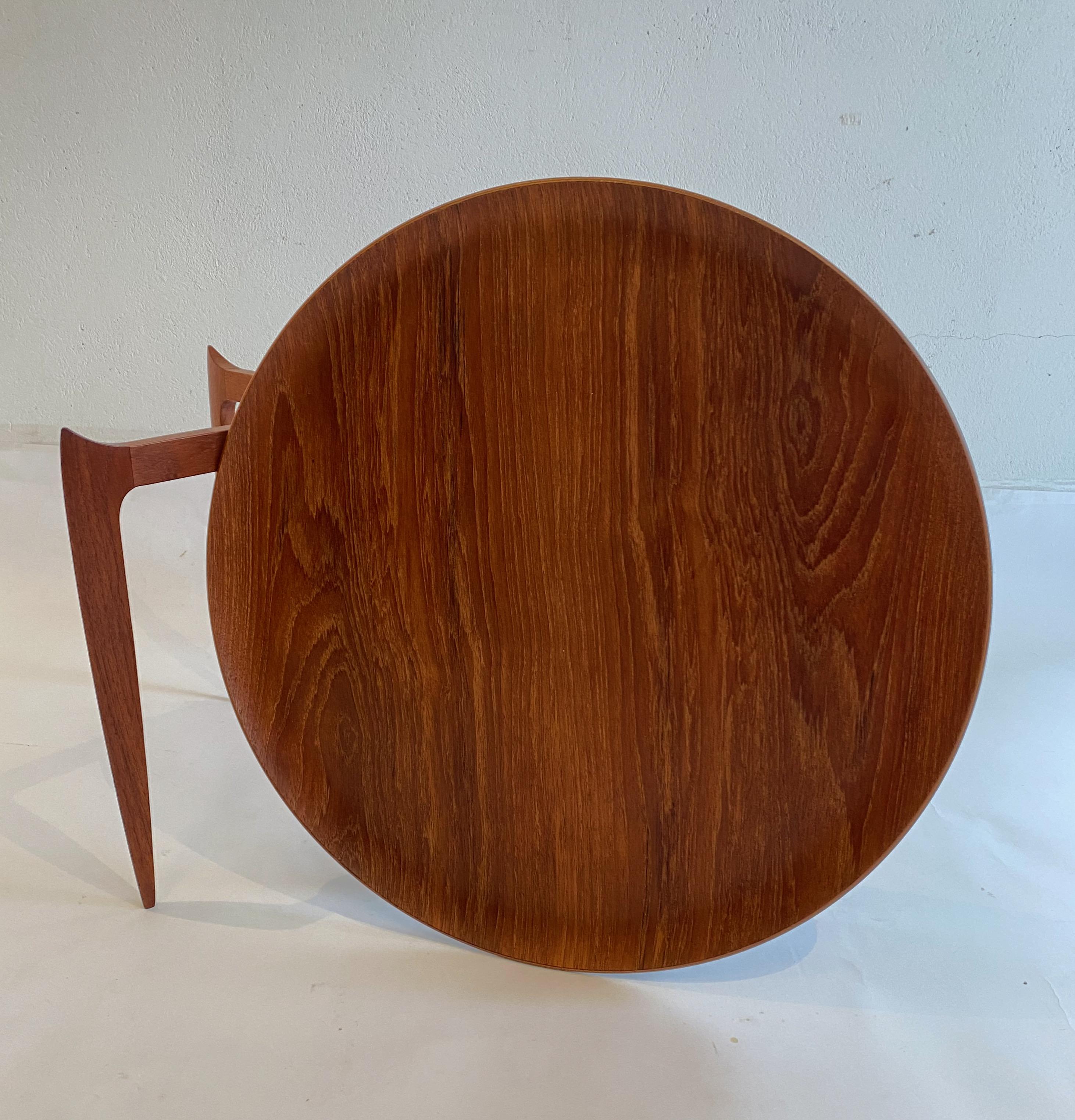 Early folding tray table designed by S.A. Willumsen & H. Engholm in 1958. Produced by Fritz Hansen during the 1950-60s. Folding base made from solid teak and metal hinges. Tray made from laminated teak. Signed with makers signature. Very good