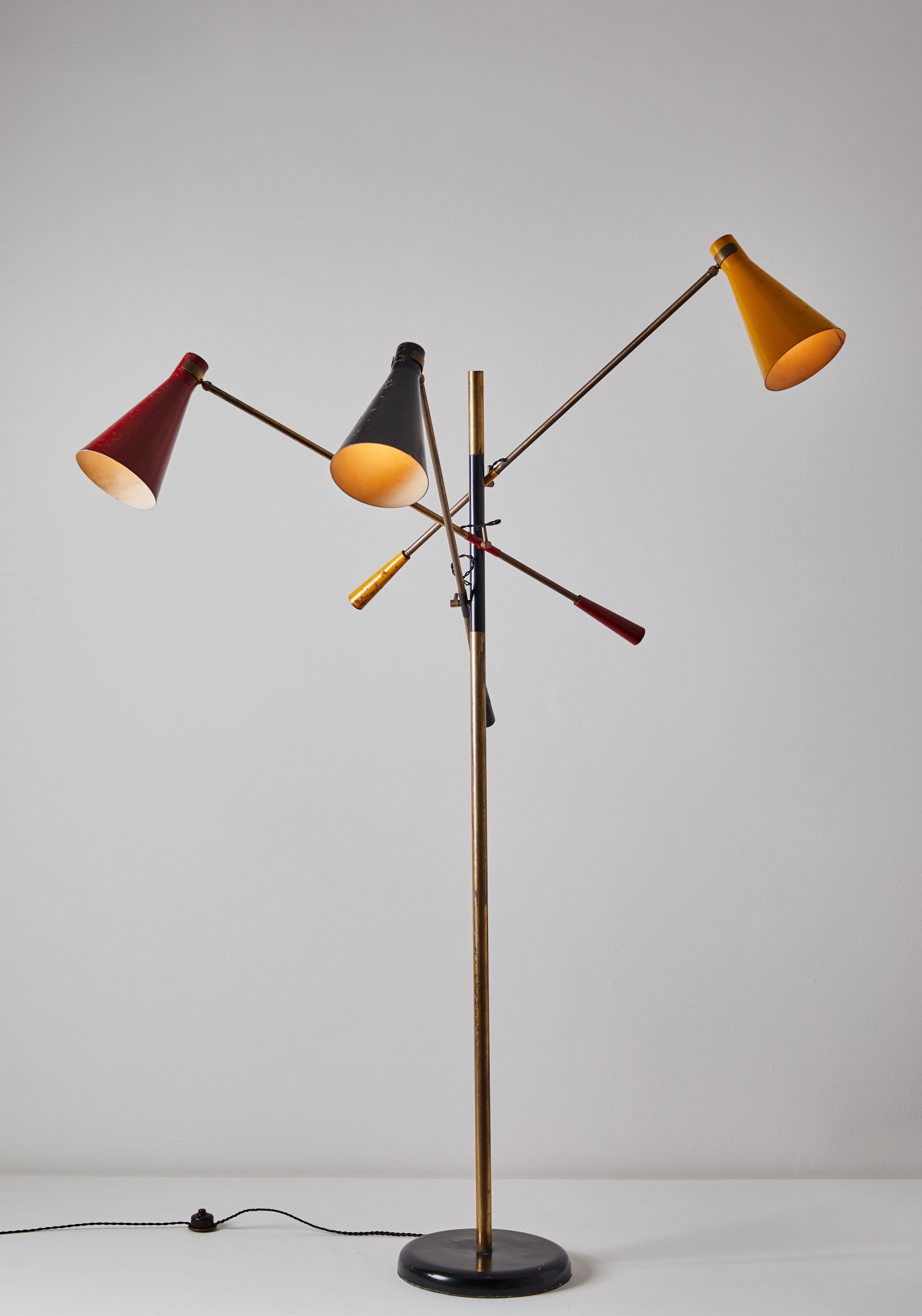Early three-arm floor lamp by Stilnovo. Designed and manufactured in Italy circa 1950s. Brass and metal with lacquered metal base. Rewired with black French twist cord. Original paint. Shades articulate in various positions. Heights of shades are
