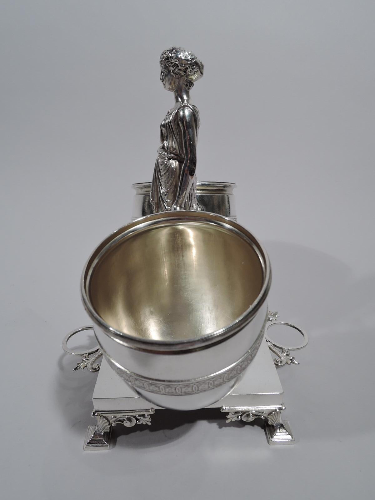 Classical sterling silver cigar holder. Made by JC Moore & Son for Tiffany & Co. in New York. The cast-figure of a draped and barefooted maiden standing on pedestal and gripping two oversized amphoras with gilt-washed interior and rosette-inset