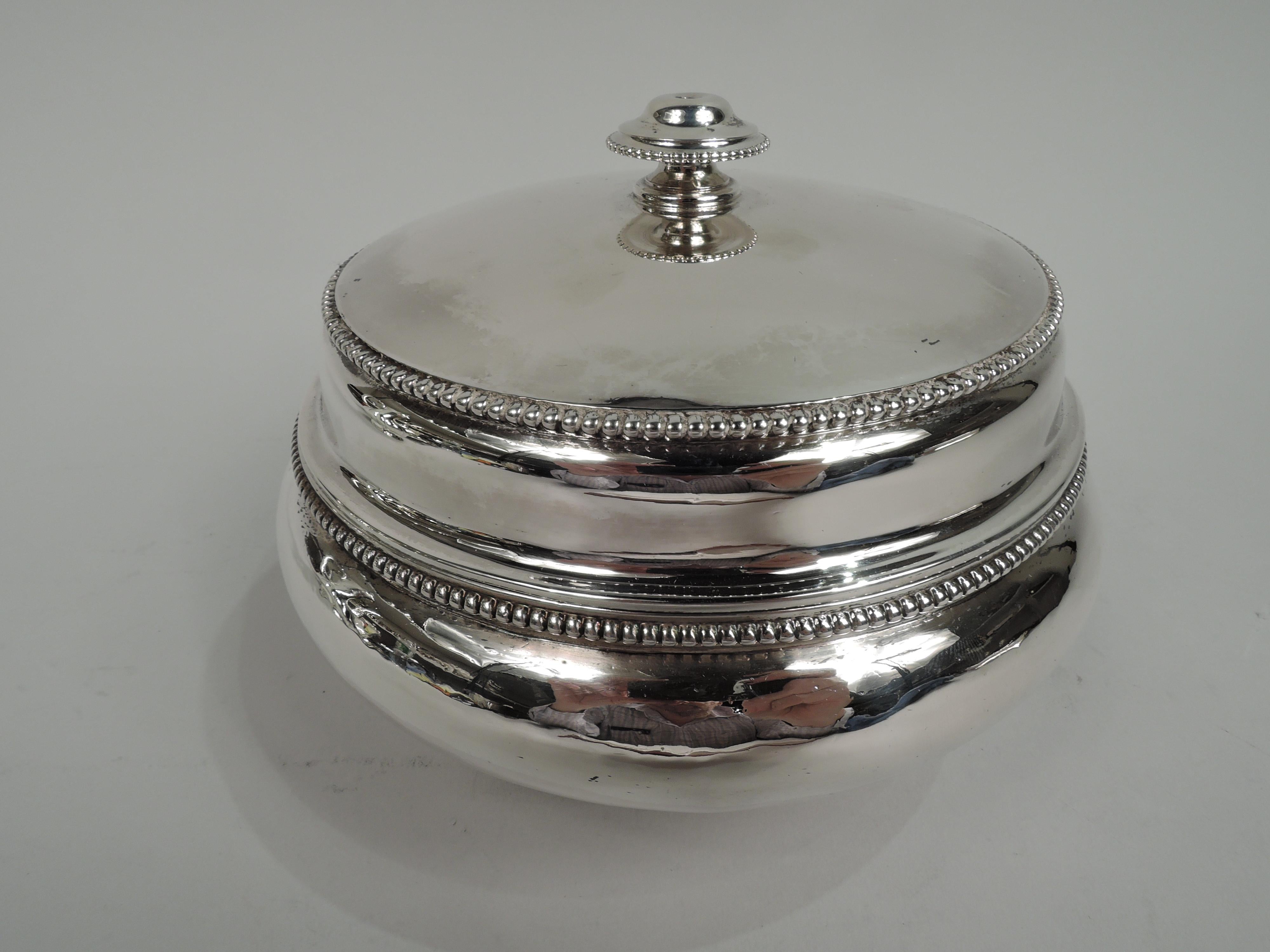 Classical sterling silver bowl. Made by Edward C. Moore for Tiffany & Co. at 550 Broadway in New York, ca 1860. Bellied on stepped and spread foot. Cover raised with tapering side and finial. Beading. Handwork visible on interior. Early maker’s and