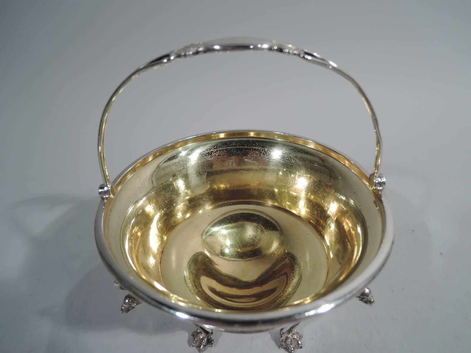 Greek Revival sterling silver basket. Made by Tiffany & Co. in New York. Bowl has tapering sides and gilt interior. On exterior is an engraved frieze on butler-finished ground in style of an ancient pot with horsemen and philosophers in Classical