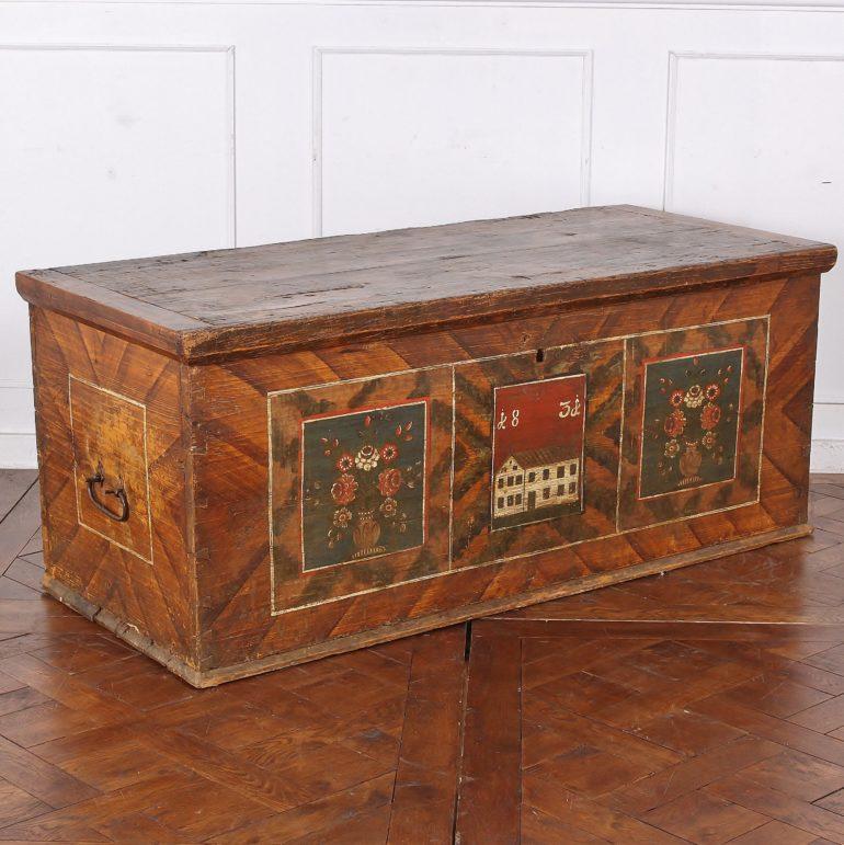 19th century painted blanket box, with faux-grain painting and naive depiction of flowers and a house; original wrought-iron handles. Dated 1831. American made, possibly Pennsylvania-Dutch.



 