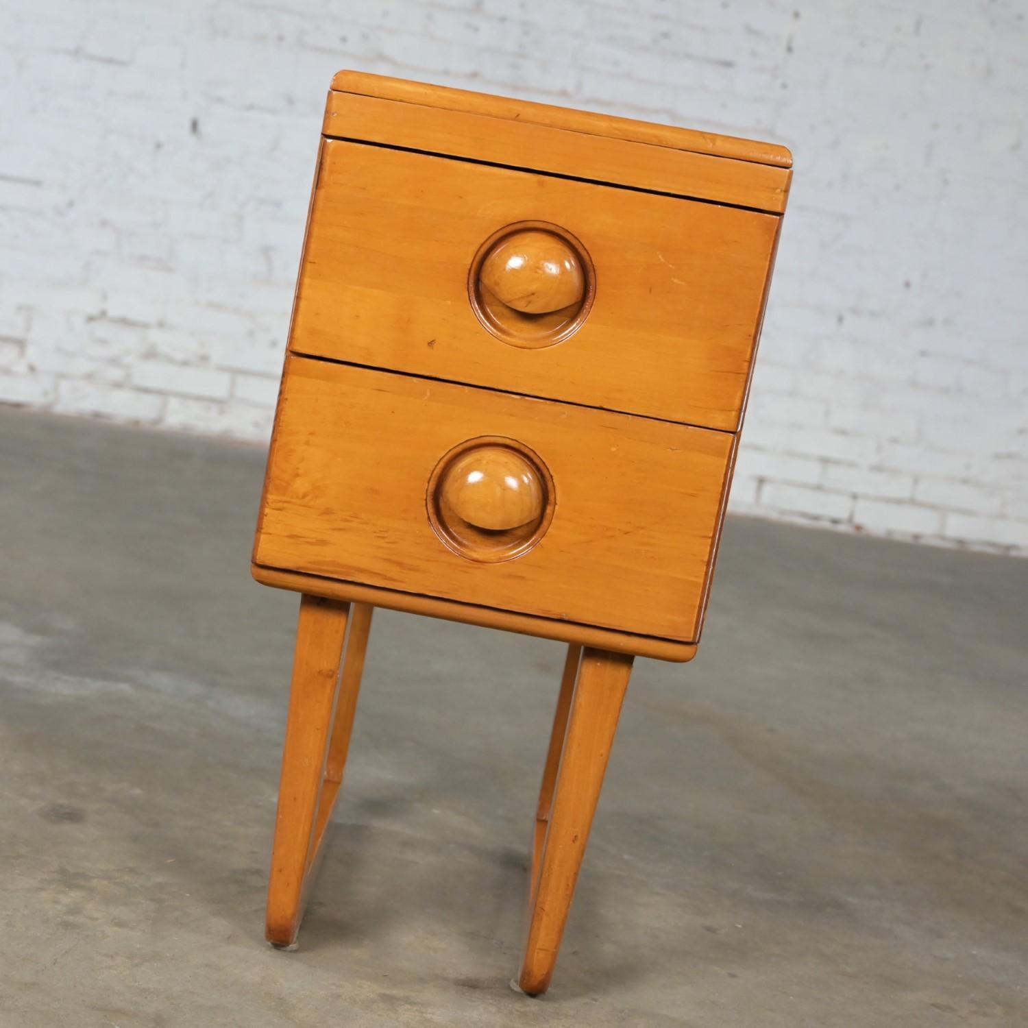 Wonderful Early to Mid-20th Century Art Moderne solid maple 2 drawer nightstand in the style of Bissman and after Russel Wright for Conant Ball. This piece has been attributed based upon archived research including online sources, vintage