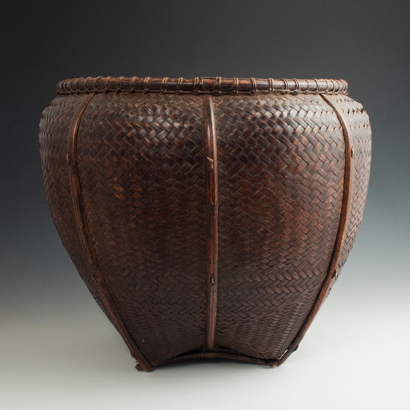 Early to mid-20th century Bamboo Collecting Basket, Attapeu Area, Laos

A large, gracefully shaped, tightly woven carrying basket from the Laotian people. It has two integrated wire loops for the shoulder straps and a slightly flattened back where