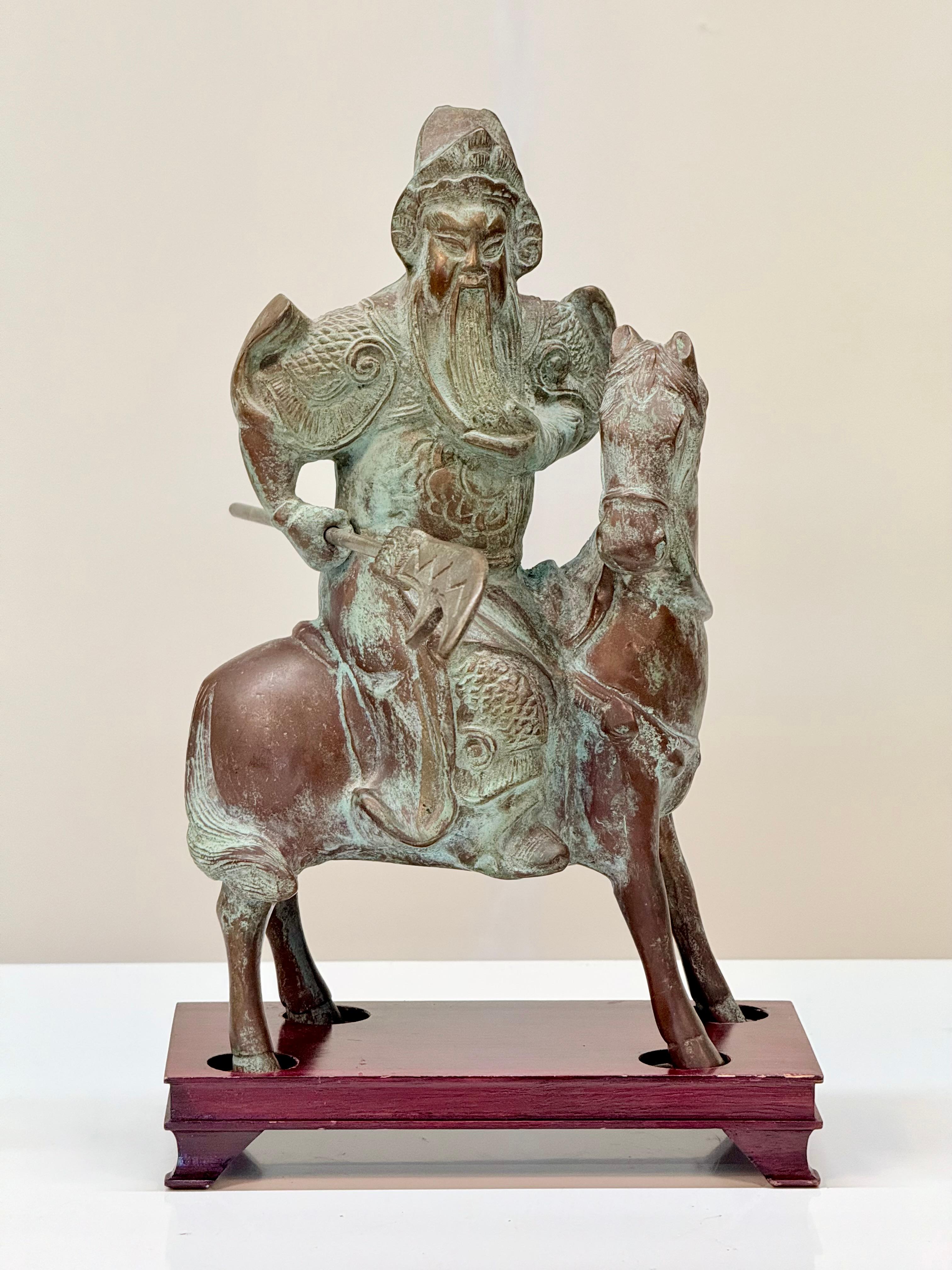 Early to Mid-20th Century Chinese Bronze Figurine of Mounted Warrior Guan Yu on Bespoke Wooden Stand

Description:
Presenting an exquisite early to mid-20th century Chinese bronze figurine of Guan Yu, the legendary warrior deity, depicted in a