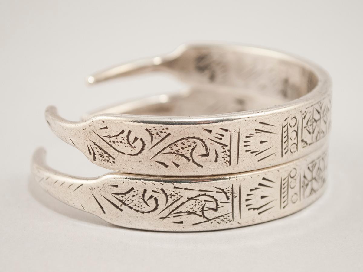 Early to mid-20th century pair of silver bracelets, Tunisia or Libya

These 'bracelets' were converted from an old pair of ear hoops; they are not attached, just stacked for the photo. The cartouche with the initials D.B is the hallmark of a master
