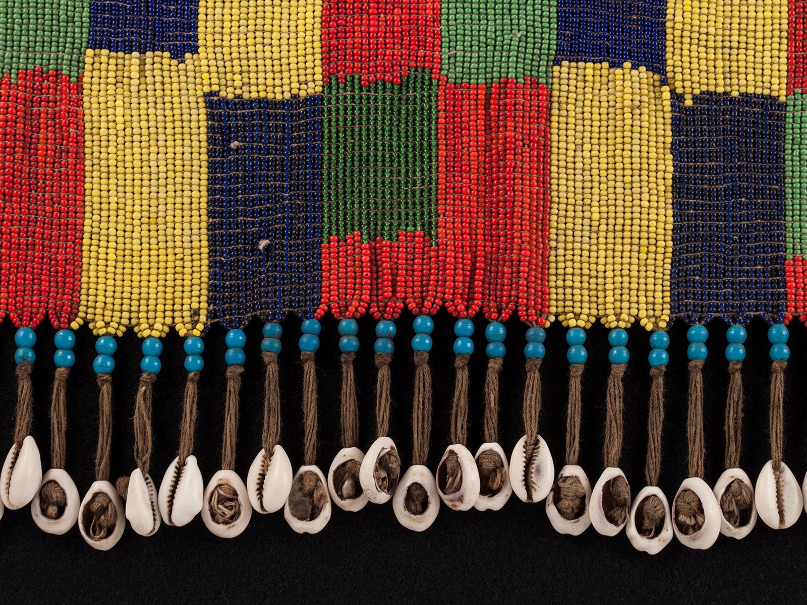 Mid-20th century cache-fesse, Negbe, Mangbetu, D.R. Congo

Early to Mid-20th century Tribal Pikuran (cache-sexe), Bana Guili people, Mandara Mountains, Cameroon

A large graphic cache-sexe made of blue, red, green and yellow trade beads mounted