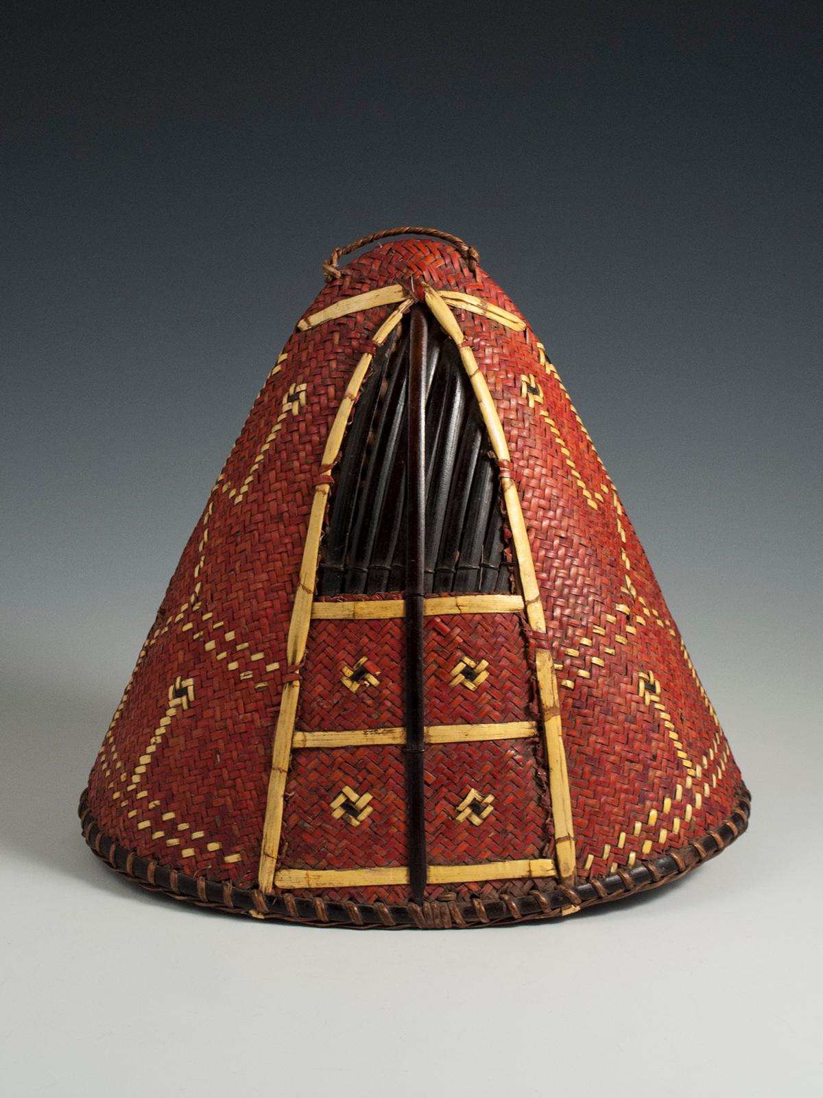 Early to mid-20th century Tribal Hat, Naga People, Northeastern India

A red-dyed woven cane conical-shaped warrior's hat has yellow orchid straw designs interwoven in typical fashion. There may have been a boar's tusk attached to the front -