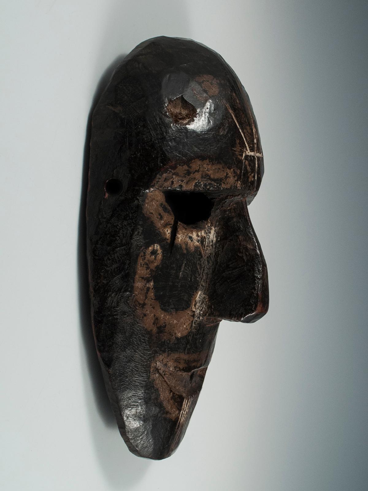 Early to mid-20th century Tribal mask, Middle Hills, Nepal

A Middle Hills mask with several unusual markings: a trisula carved into the forehead, white painted semicircle on left cheek and paint around eyes and mouth, several vertical incised