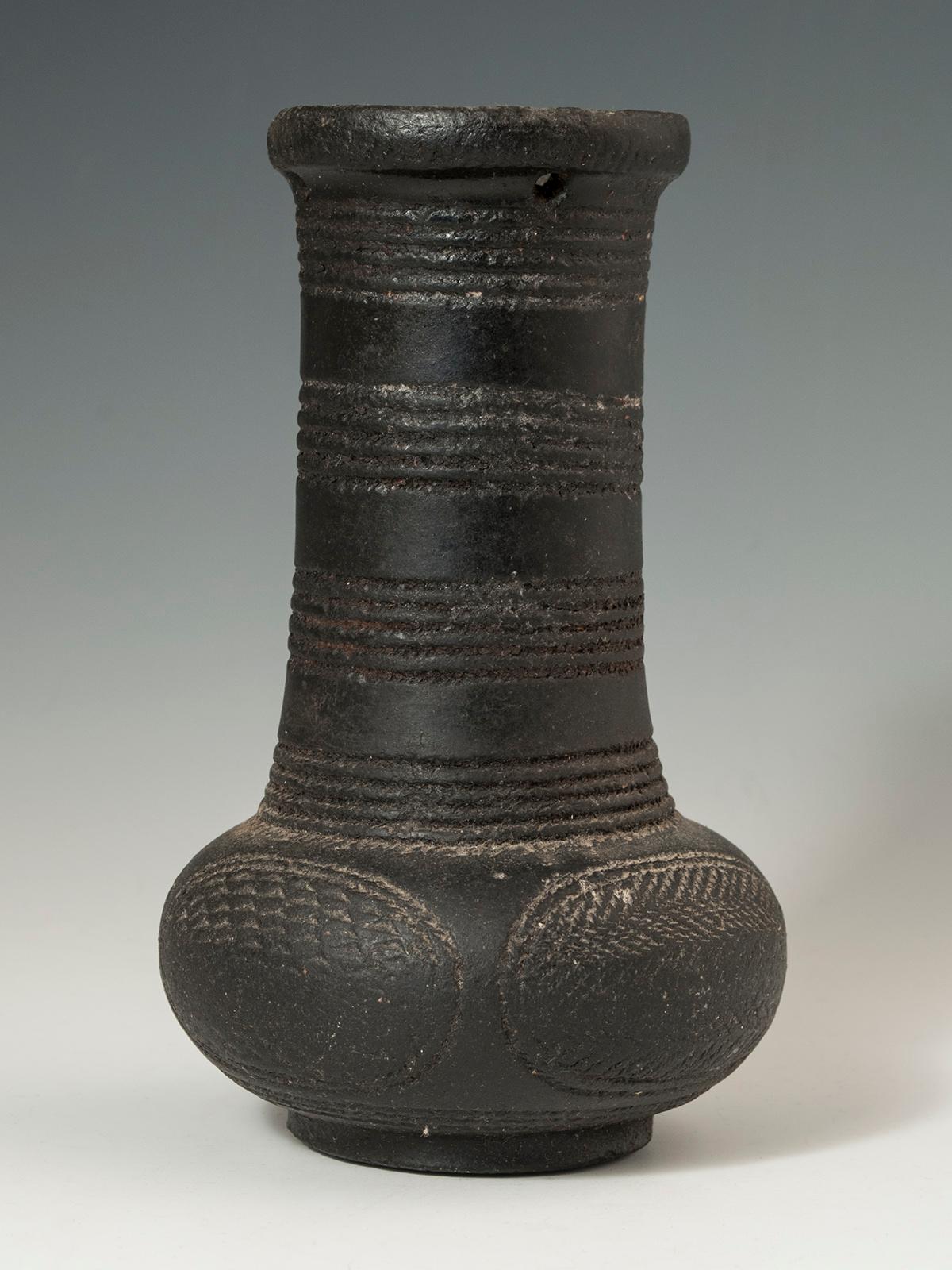 Early to mid-20th century tribal terracotta apothecary vessel, D.R. Congo

It is common for vessels from the Mangbetu to have figurative elements; much more unusual for them to be of geometric design. This one has incised bands on the neck and four