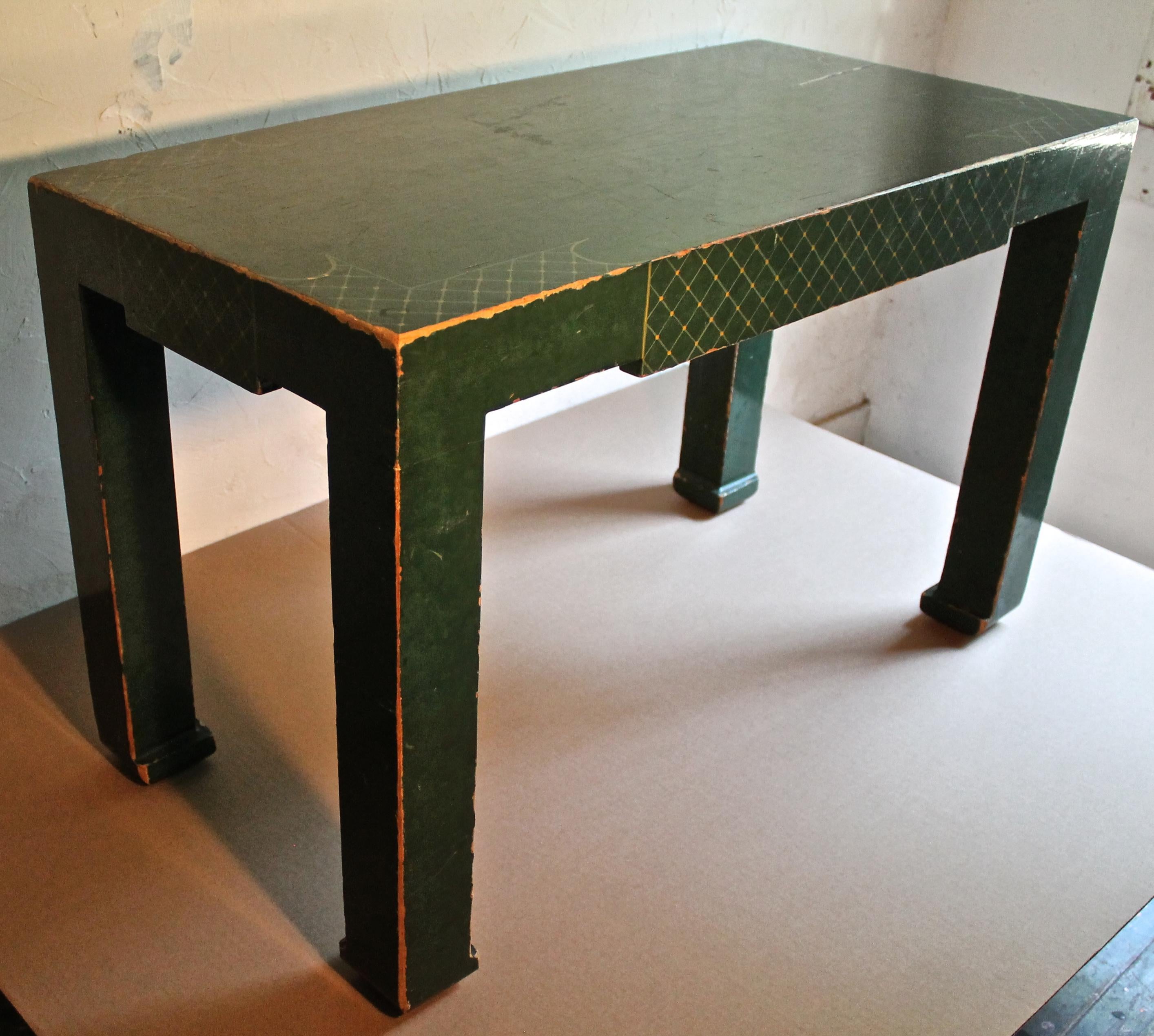 Gold criss crosses over a deep phalo green lacquer. Parsons in form but chinoiserie in detail.